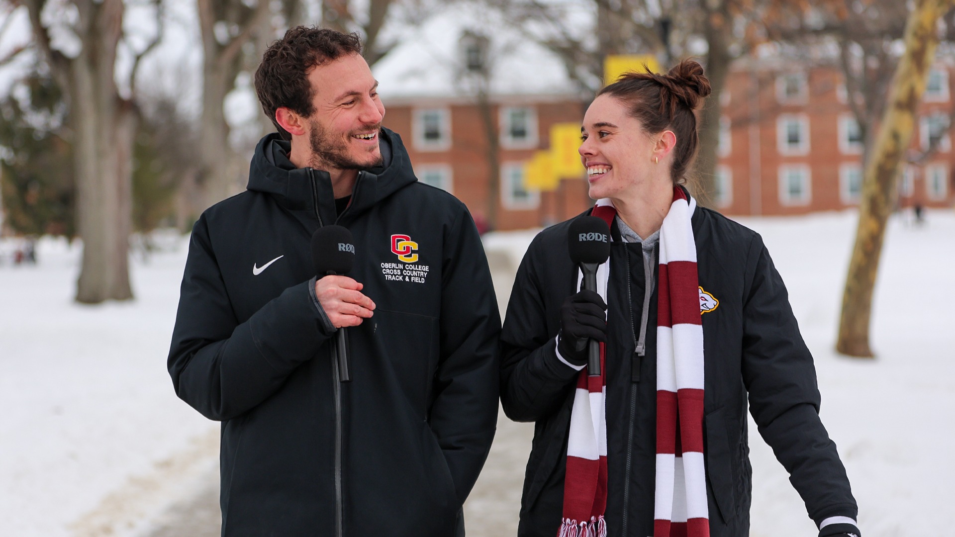 Ben Wach and Abigail Yunker smiling while walking on campus in the winter