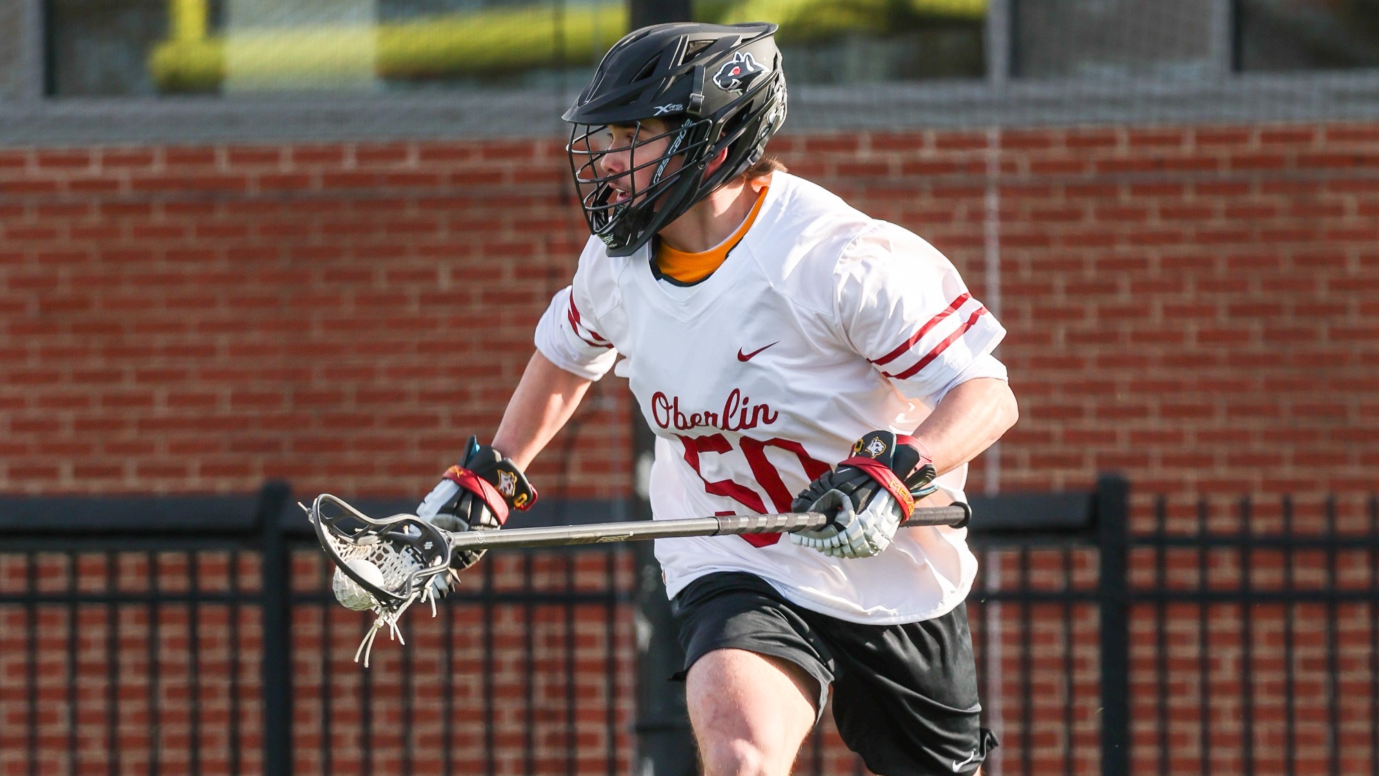 Cooper Rand running with ball in lacrosse stick