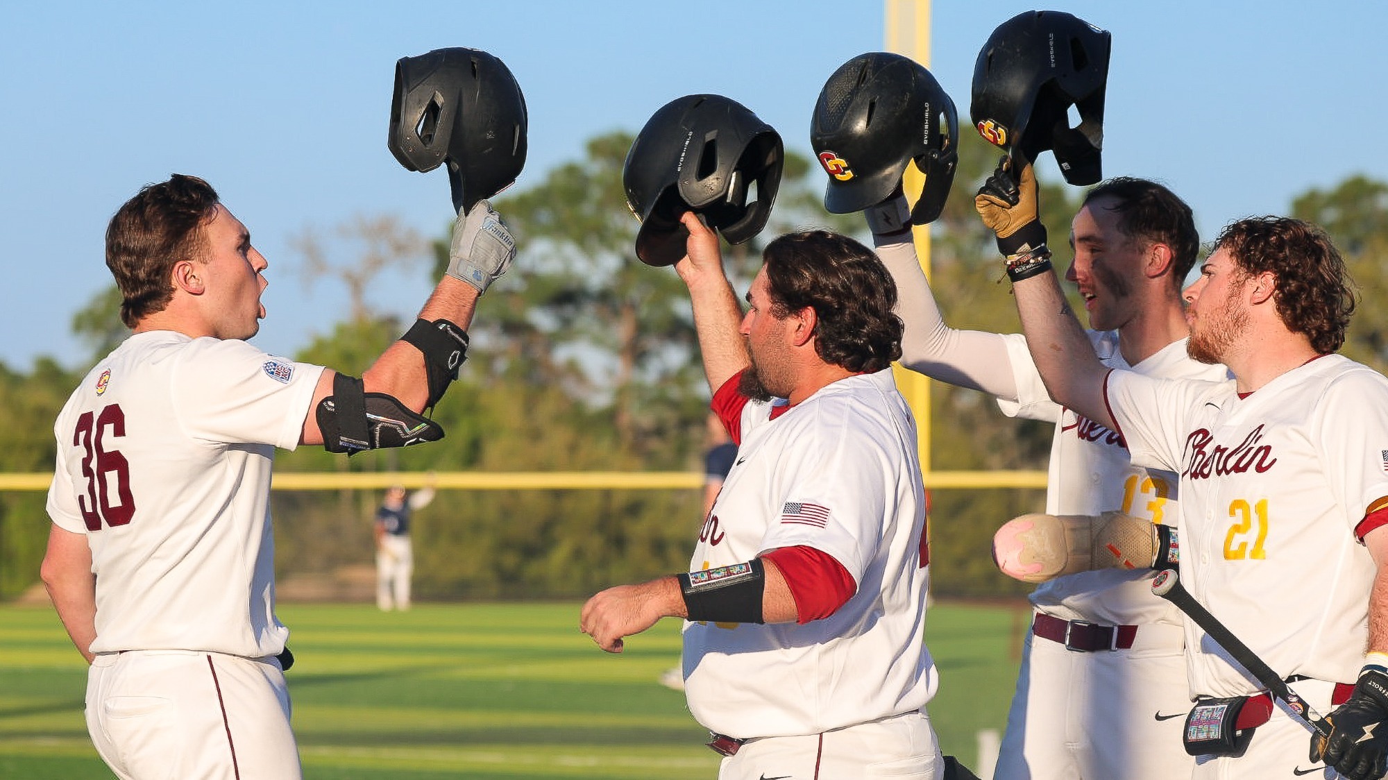 Daniel Krabill yelling cheering tapping helmets with Kyle Baxt, Samuel Labrecque, and Nik Mezzanote