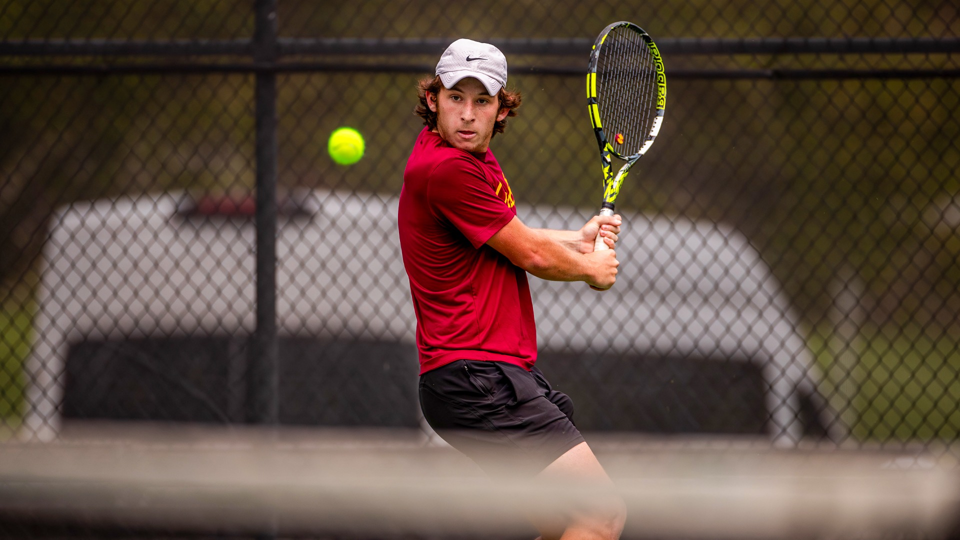 Ben Tichauer preparing to strike a tennis ball