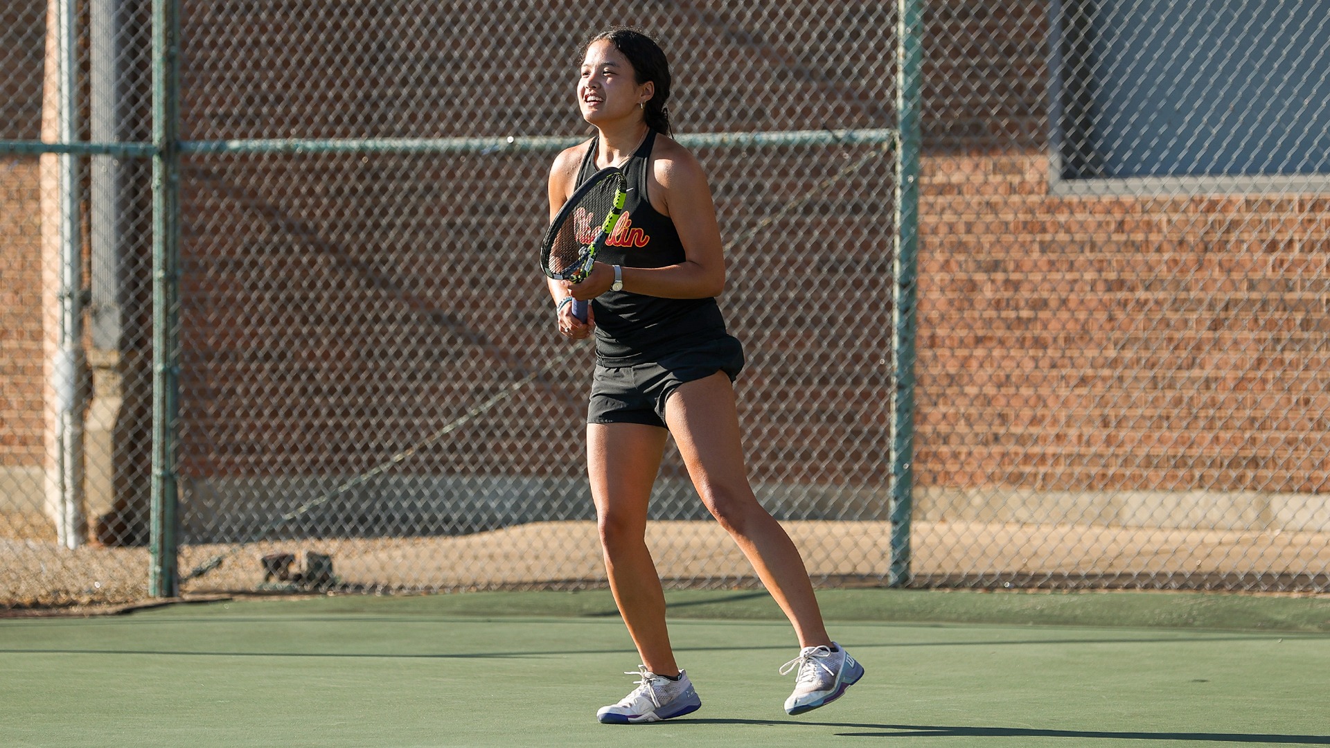 Olivia Wollner smiling on the tennis court