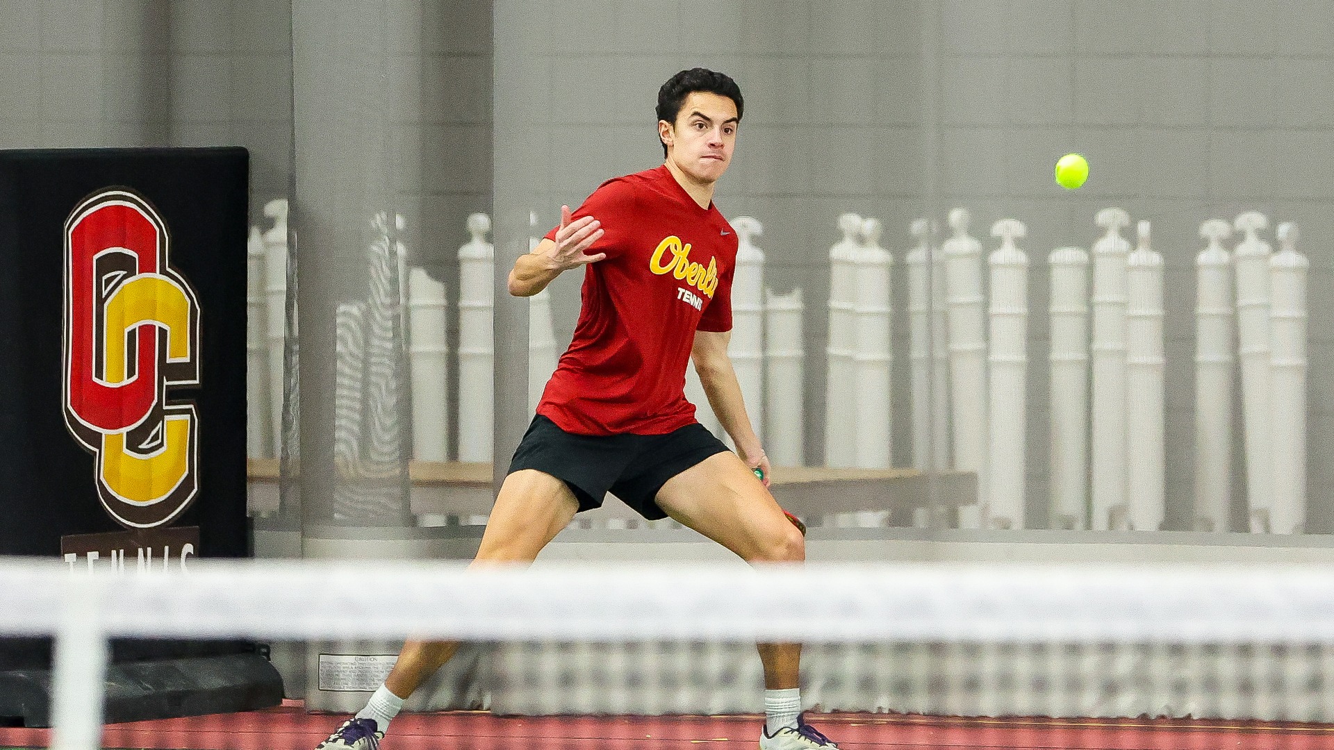 Sebastien Naginski lines up to hit a tennis ball