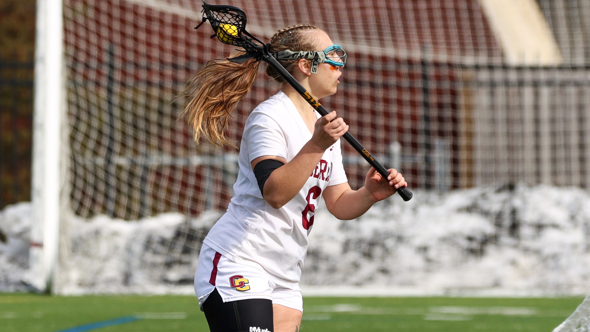 Kylie Thompson looking to right with ball in her lacrosse stick