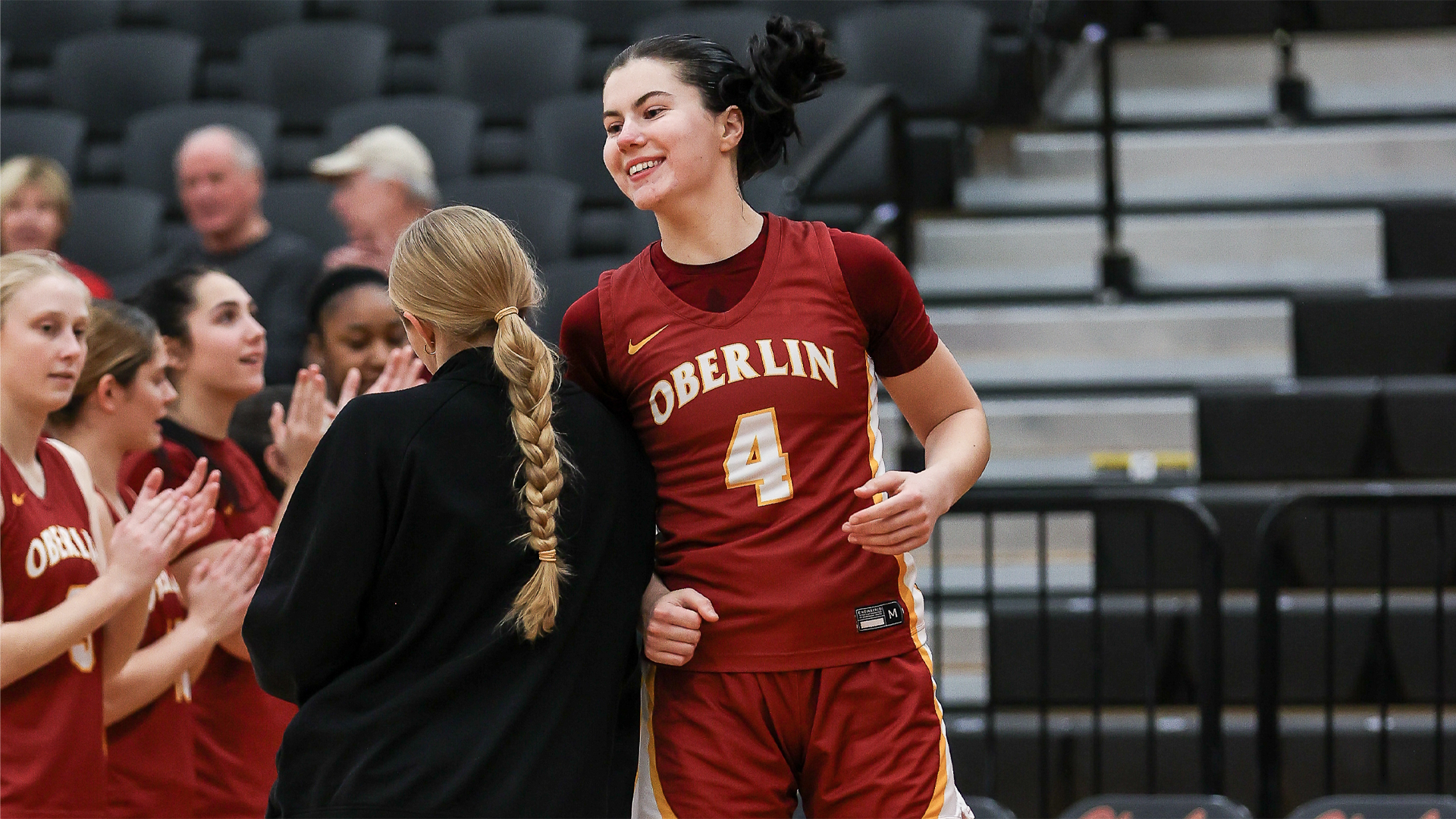 Angela Kumler jumping and smiling during starting lineup announcements