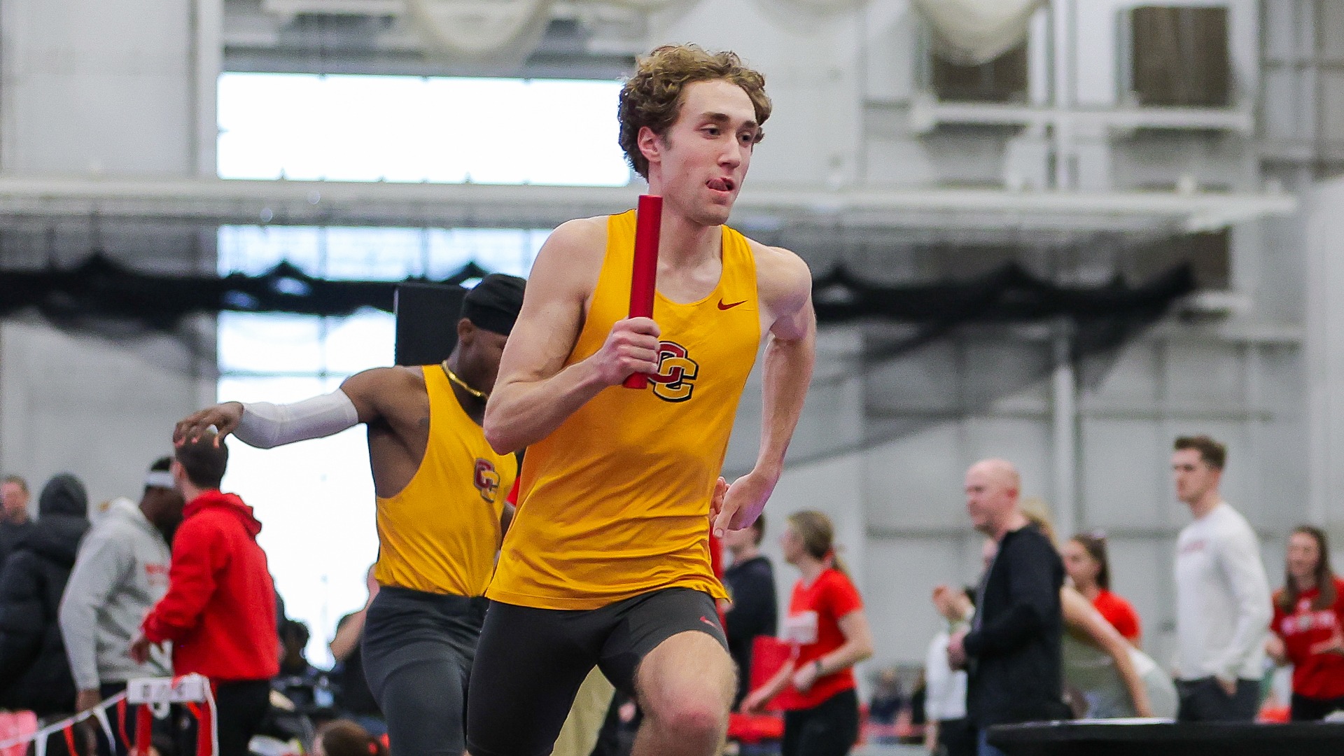 Cooper Tanski running with the baton