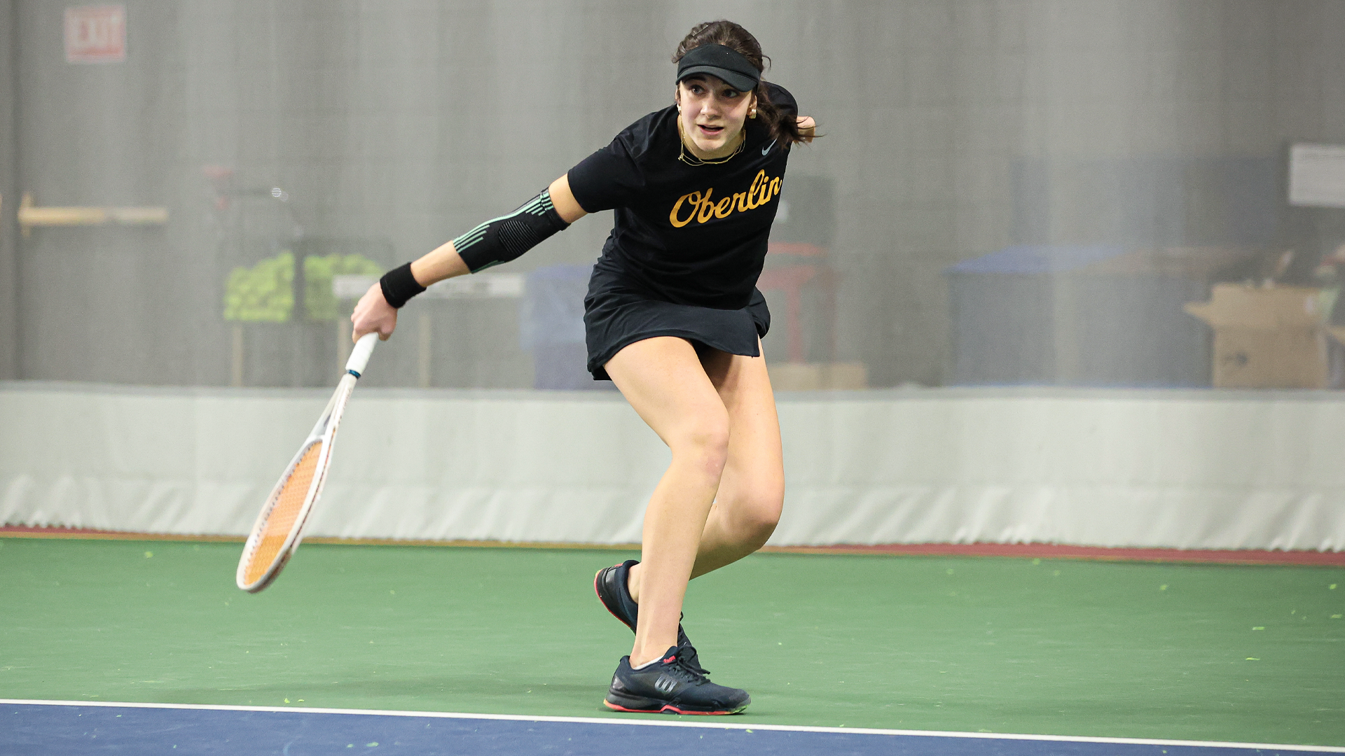 Stella Kollmansberger following through on a backhand slice