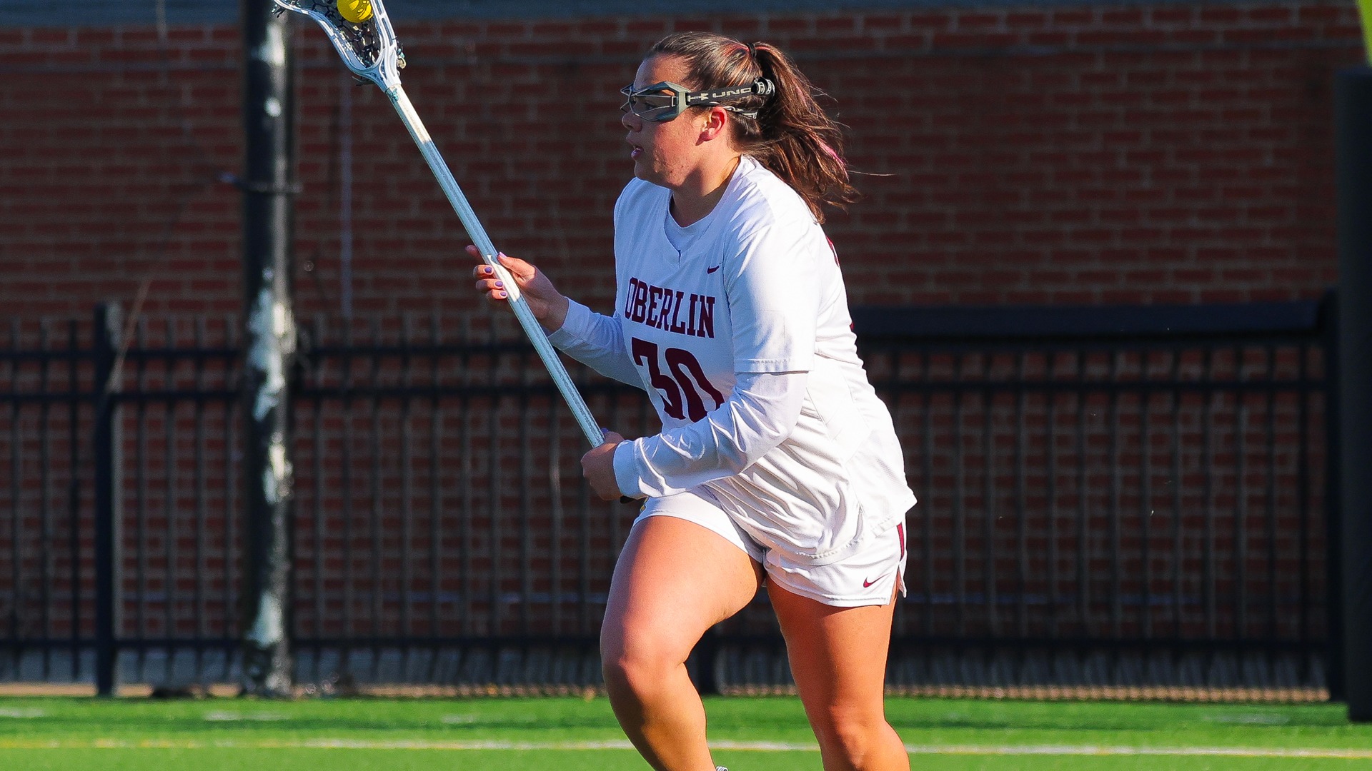 Mya Valez running with the ball in her lacrosse stick