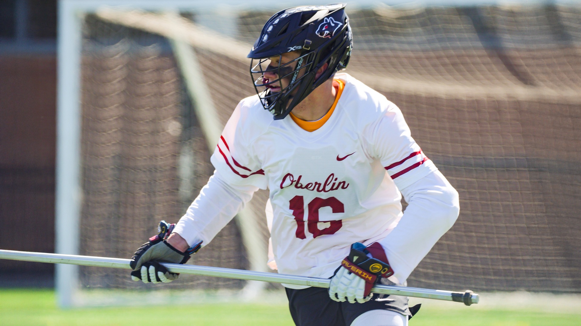 Colin Taylor running to the left with his lacrosse stick