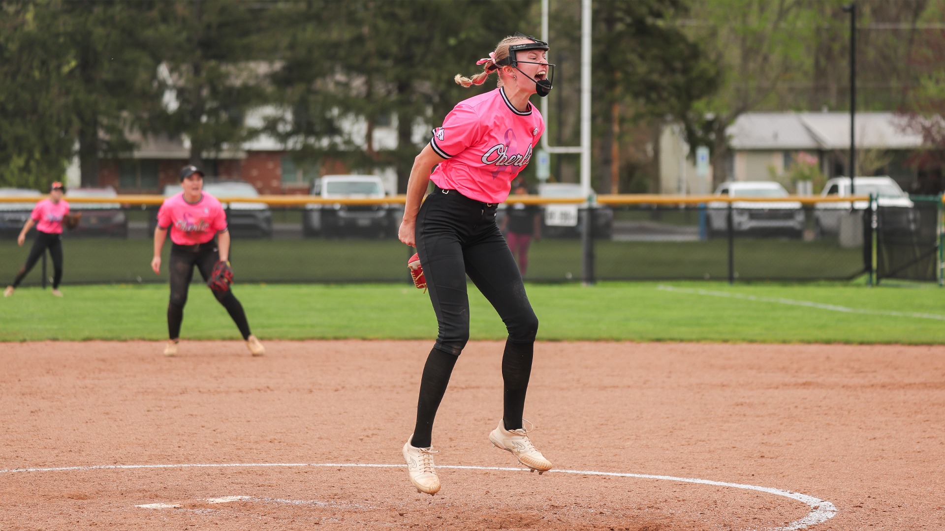 Hailey Alspach jumping and cheering after getting a strikeout