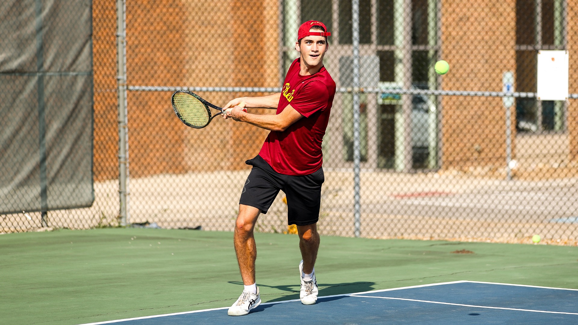 Brady Huggett lining up to hit a tennis ball