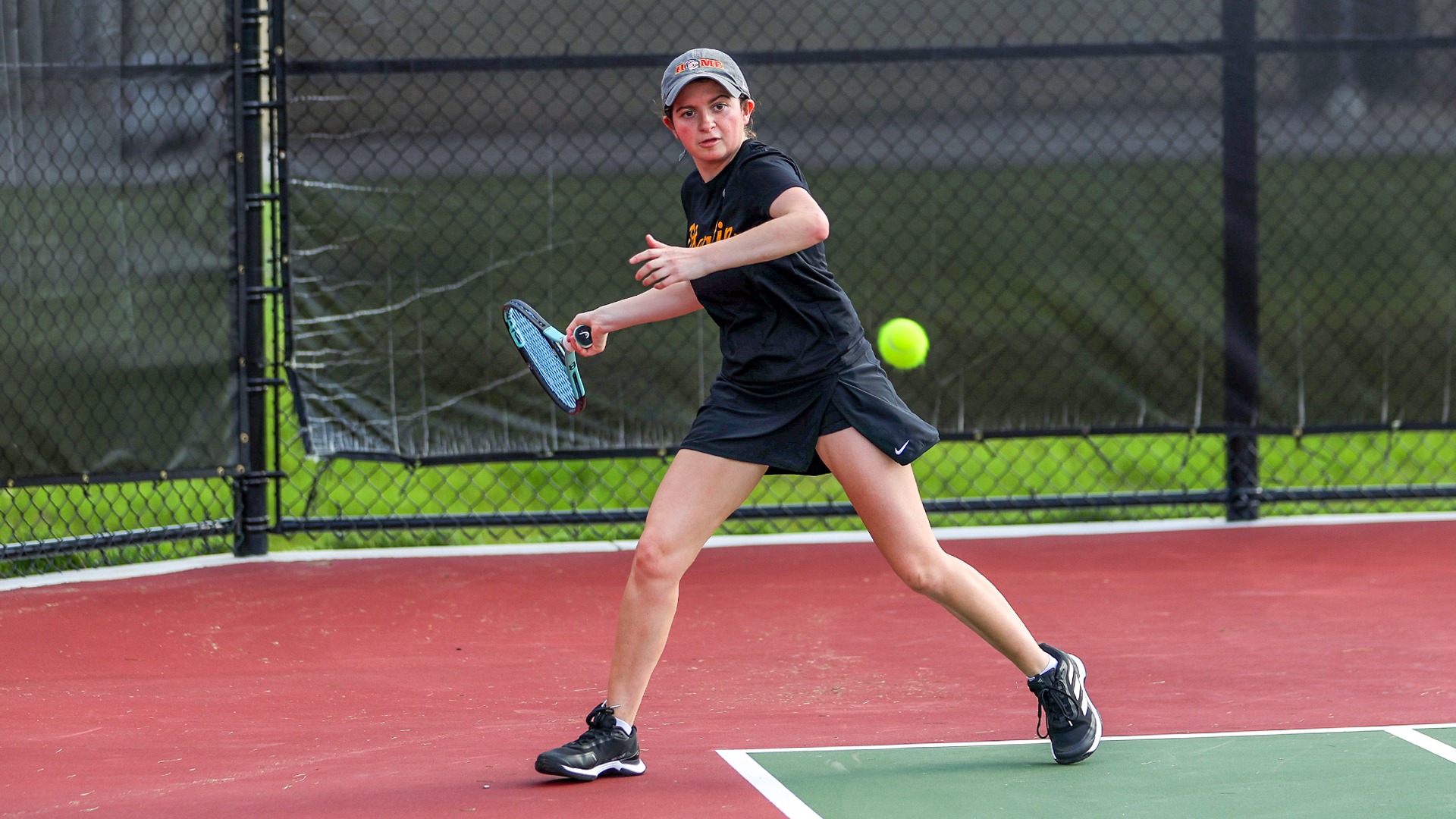 Eva Lopez running to swing at the tennis ball