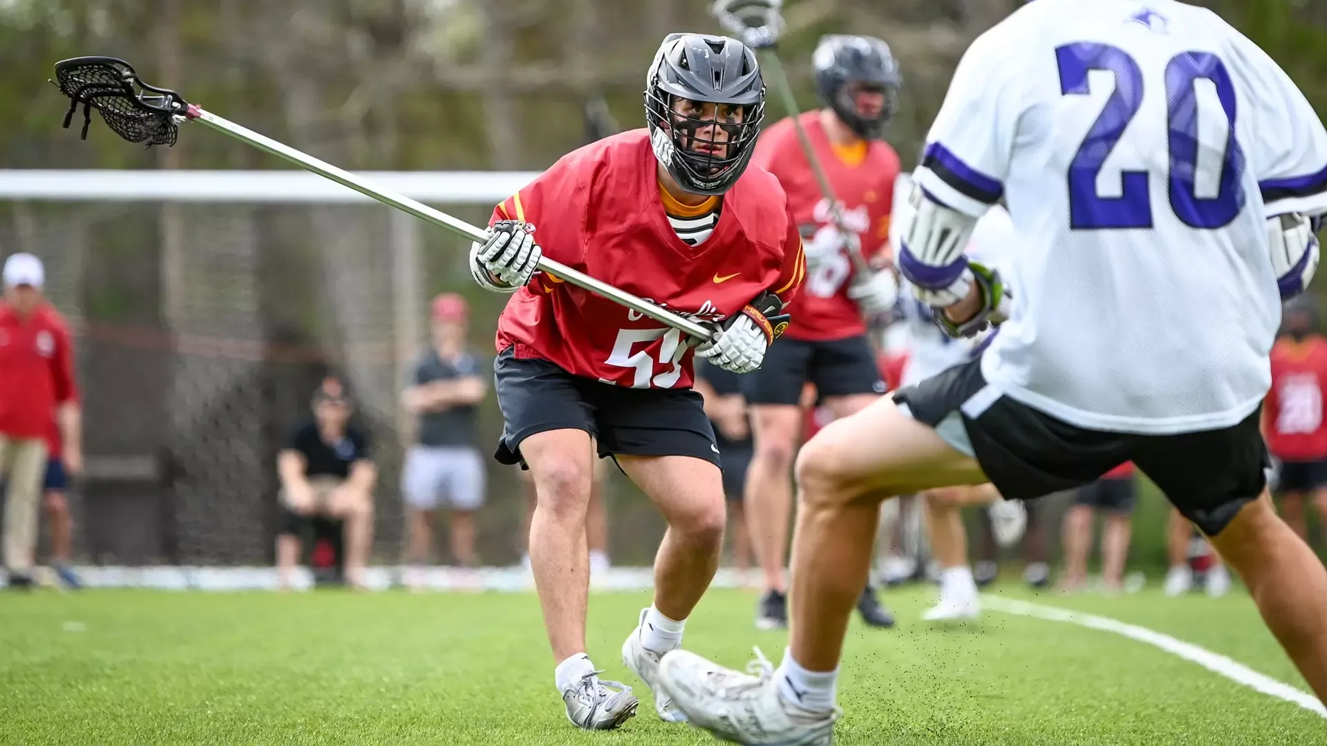 Chris Totonis staring down a Kenyon defending with his stick off to the left