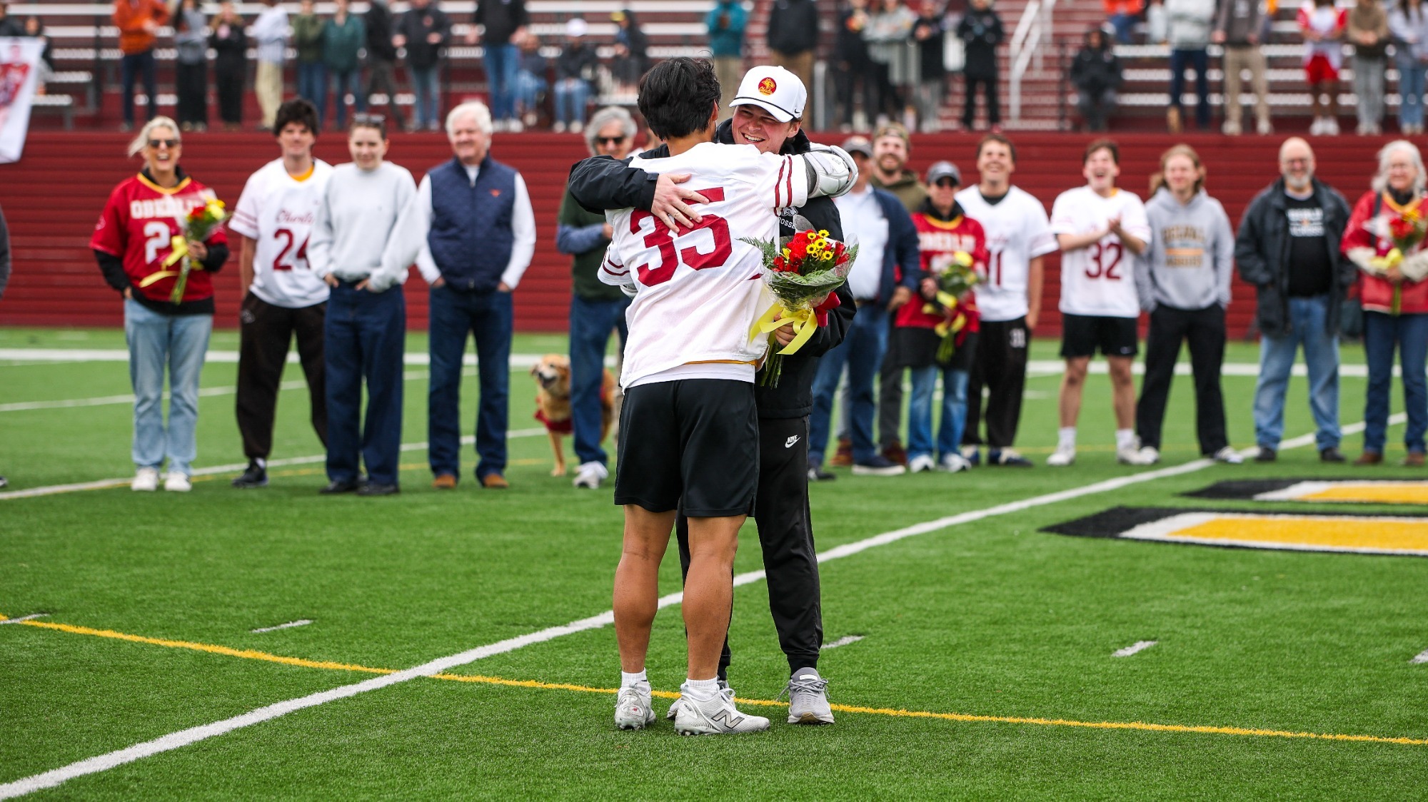 Hwaejin Chung hugging and smiling coach on Senior Day