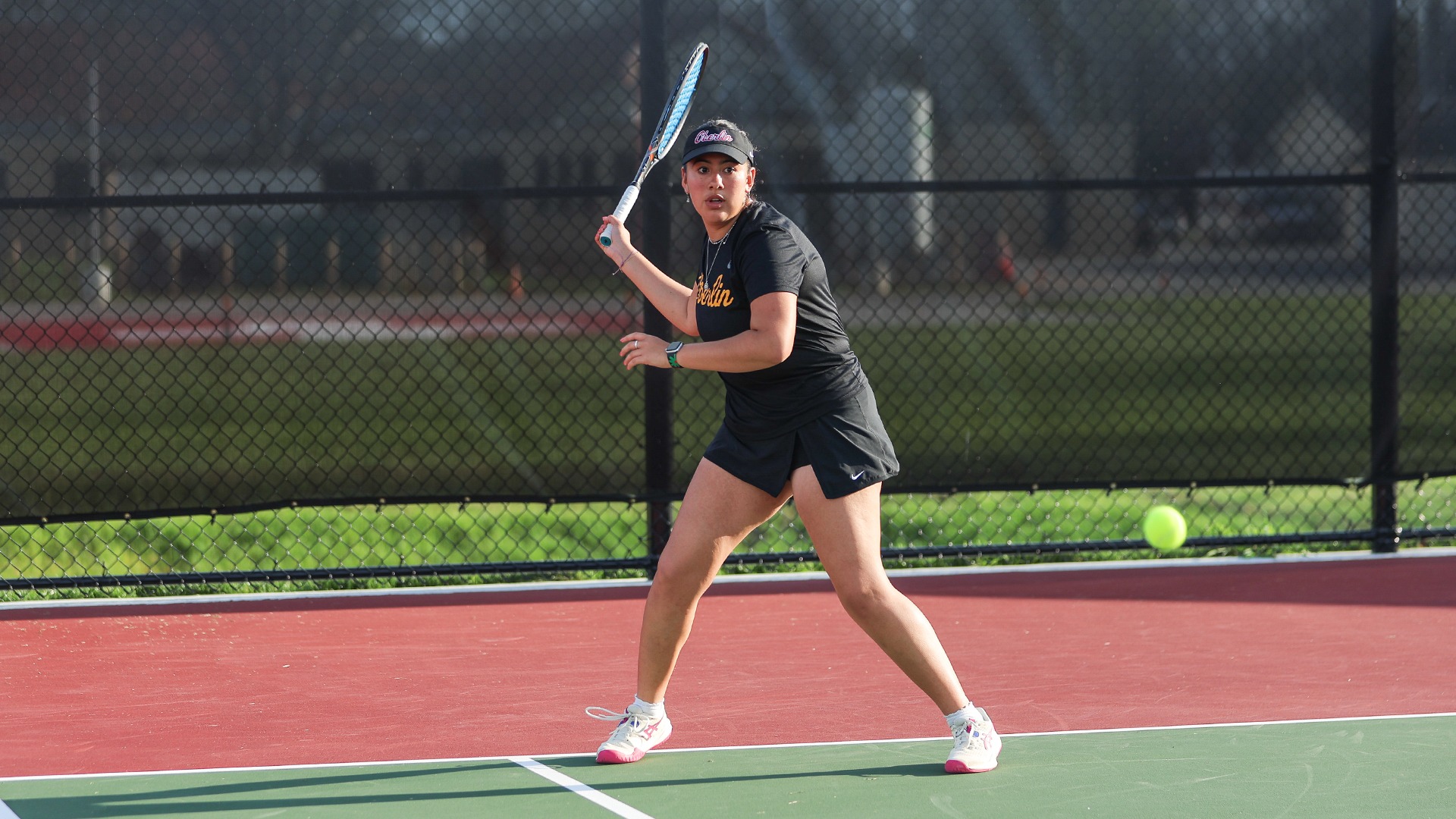 Olivia Guzman preparing to return a tennis volley