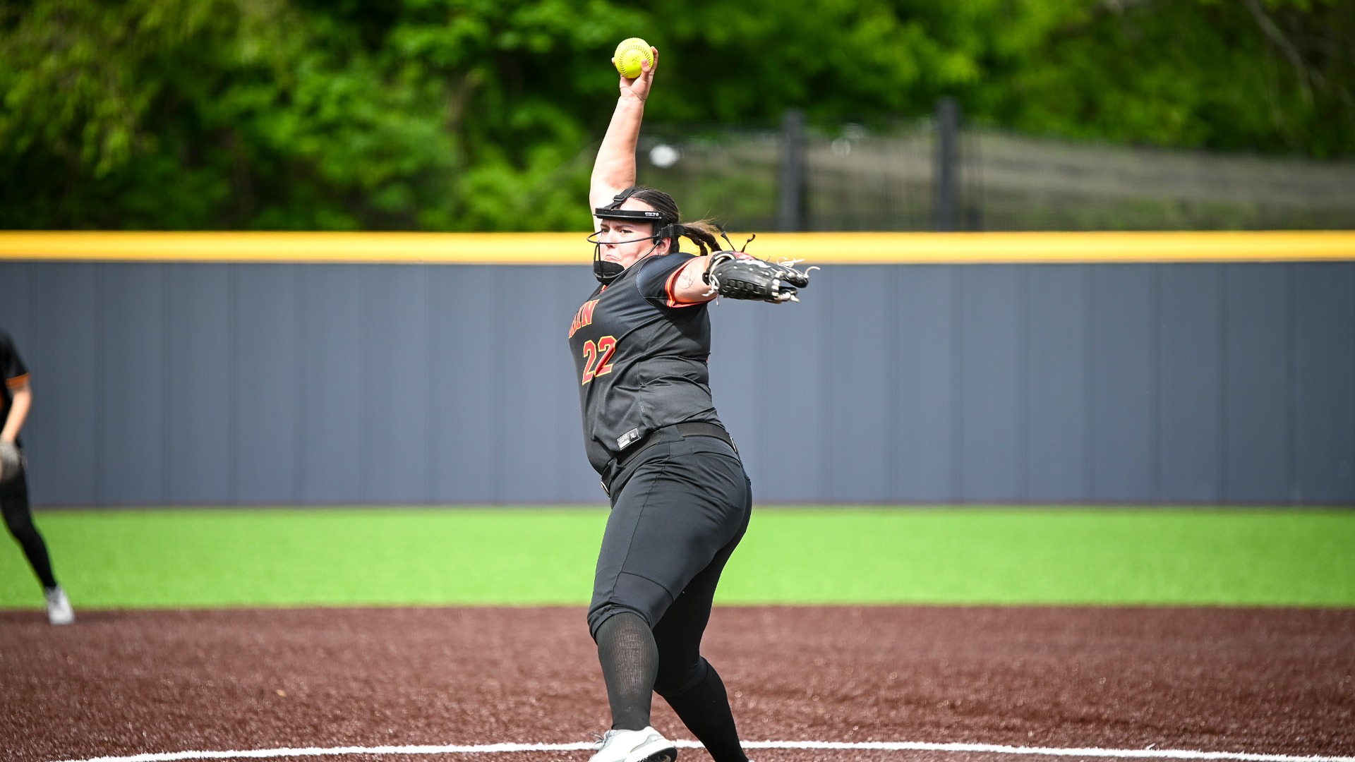 Olivia Bey pitching the softball