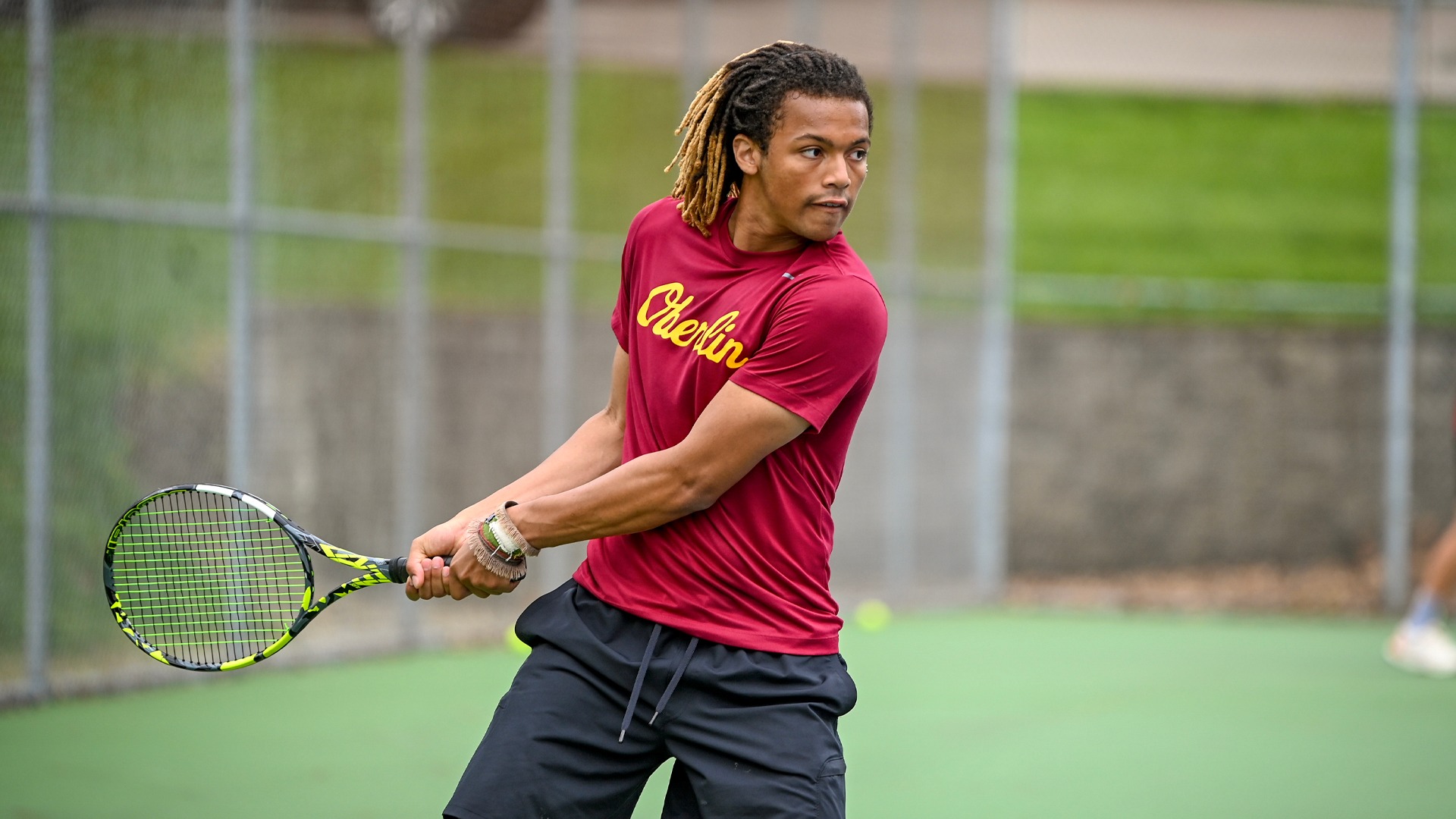 Dash Smith winding up his backhand with a tennis racket to return a ball