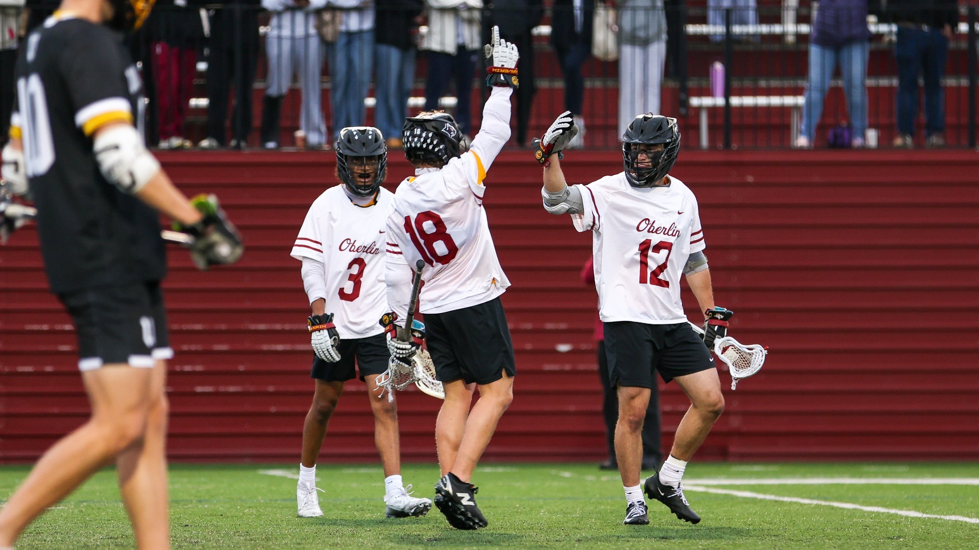 Solomon Brennan and Cooper Zancosky cheering with Asher Friedman holding up a number one