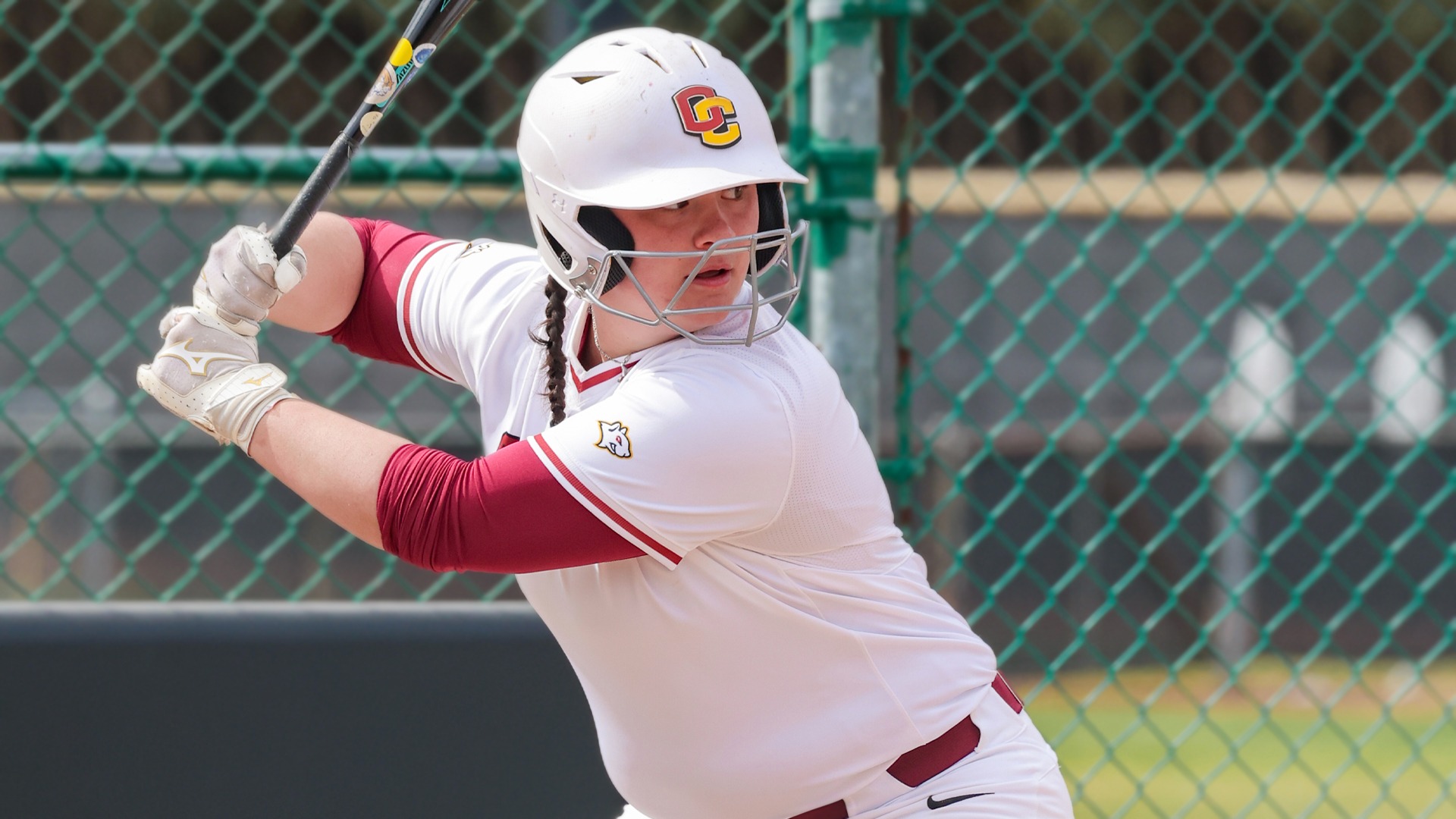 Ava Soldo facing right, with the softball bat behind her head