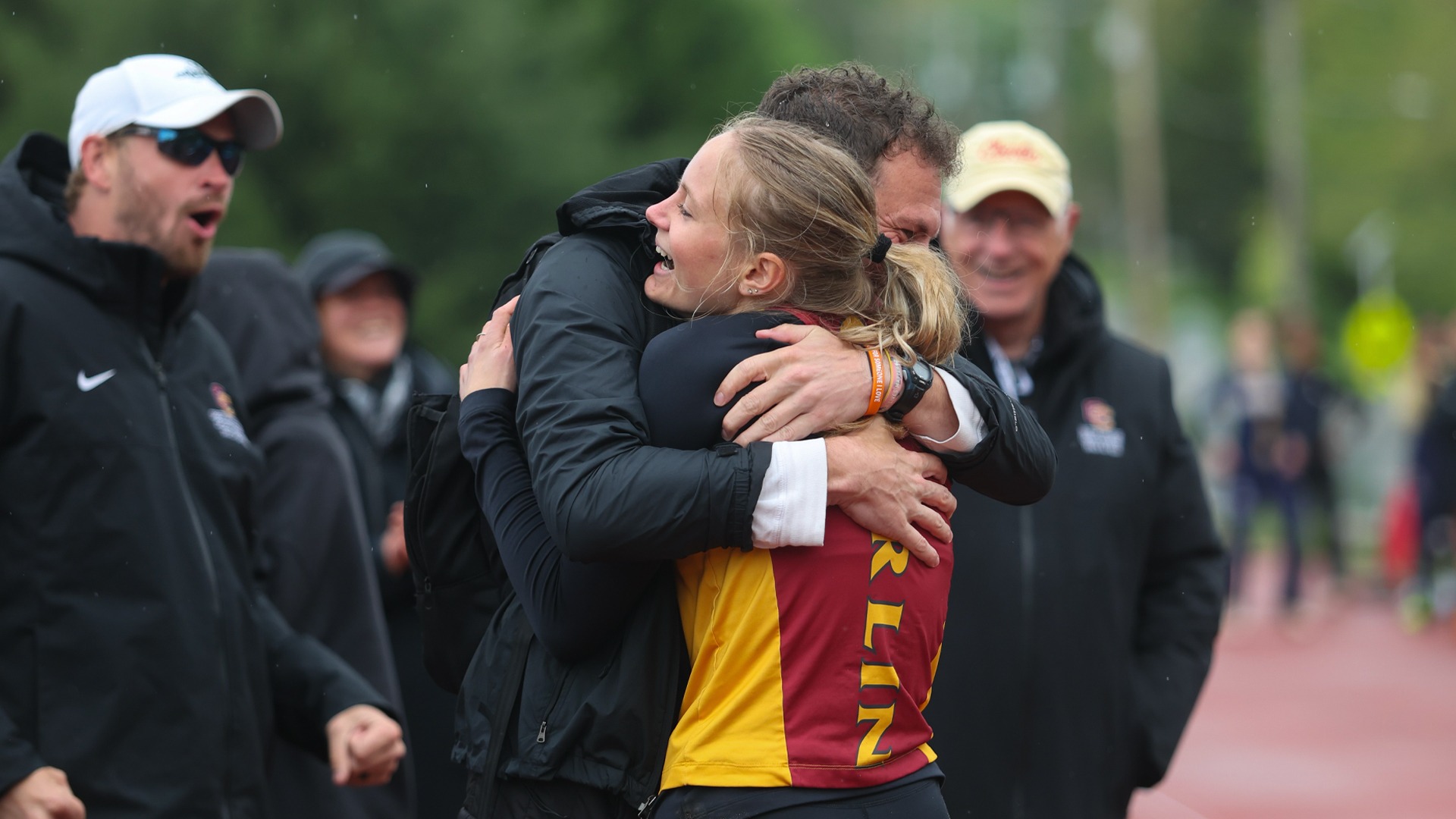 Anna Fritz hugs Head Coach Ben Wach after breaking long jump school record
