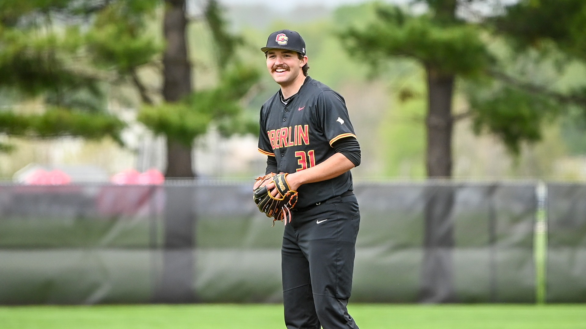 Calvin Burkholder smiling on the baseball mound