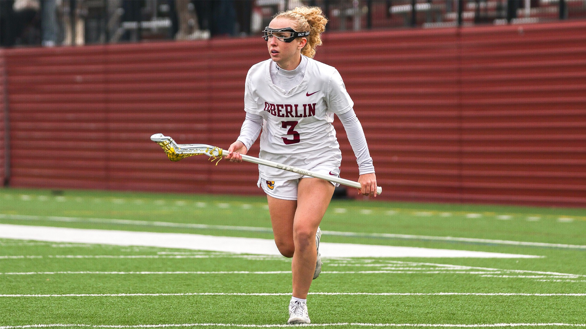 Megan Hiller running with the lacrosse ball in her stick