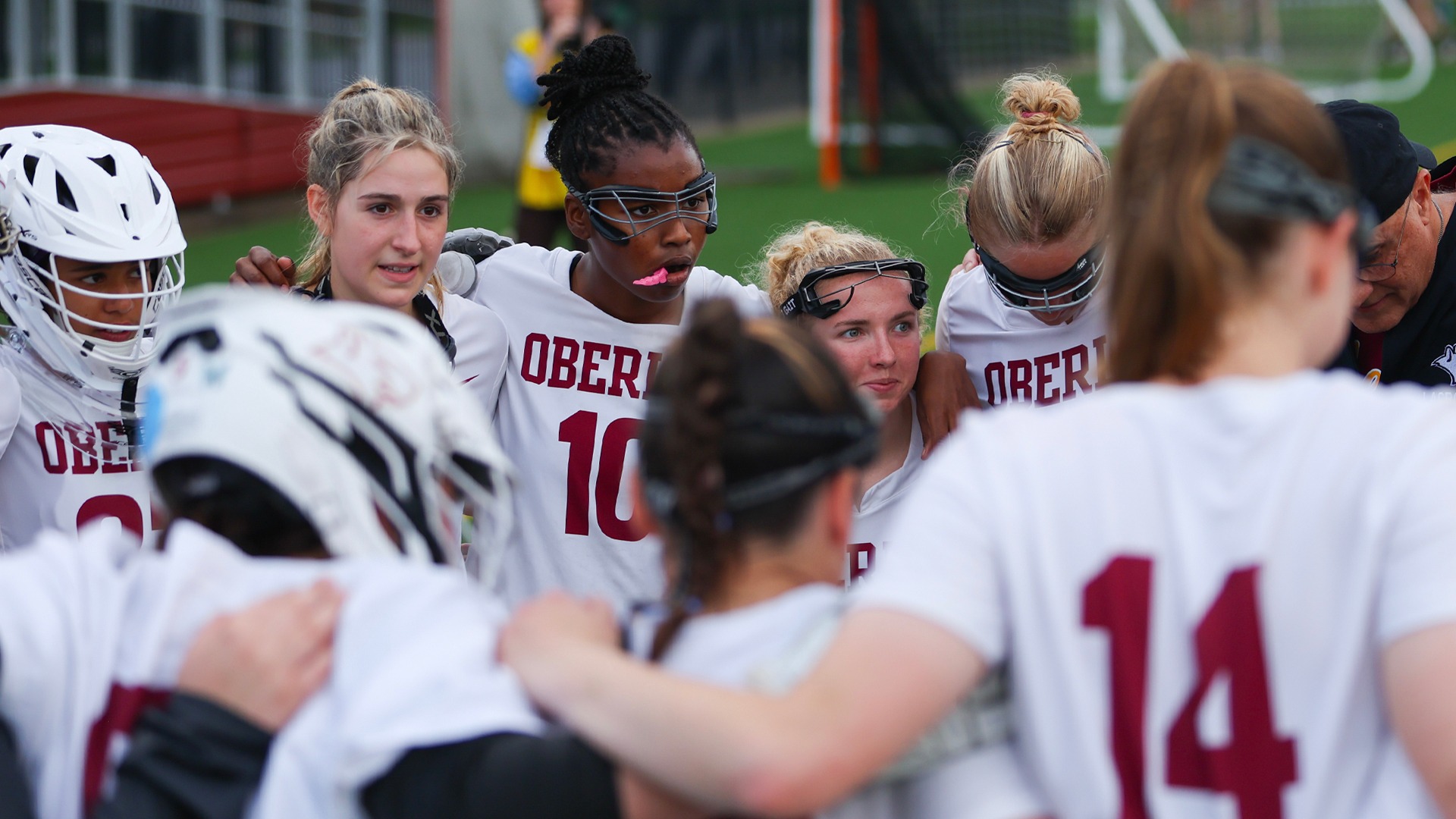 Women's lacrosse in a team huddle
