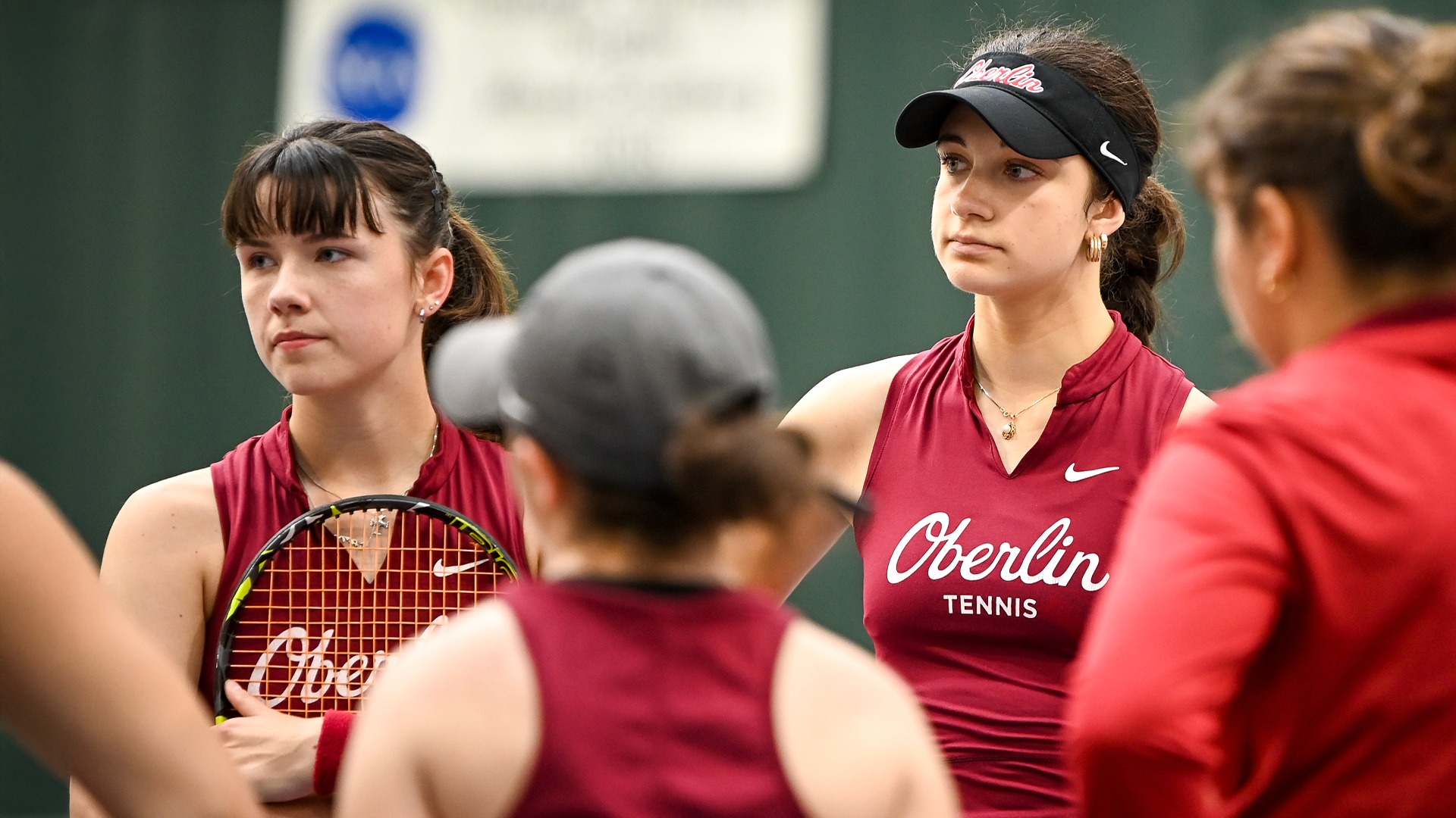 Scarlett Kingston and Stella Kollmansberger listening to team huddle