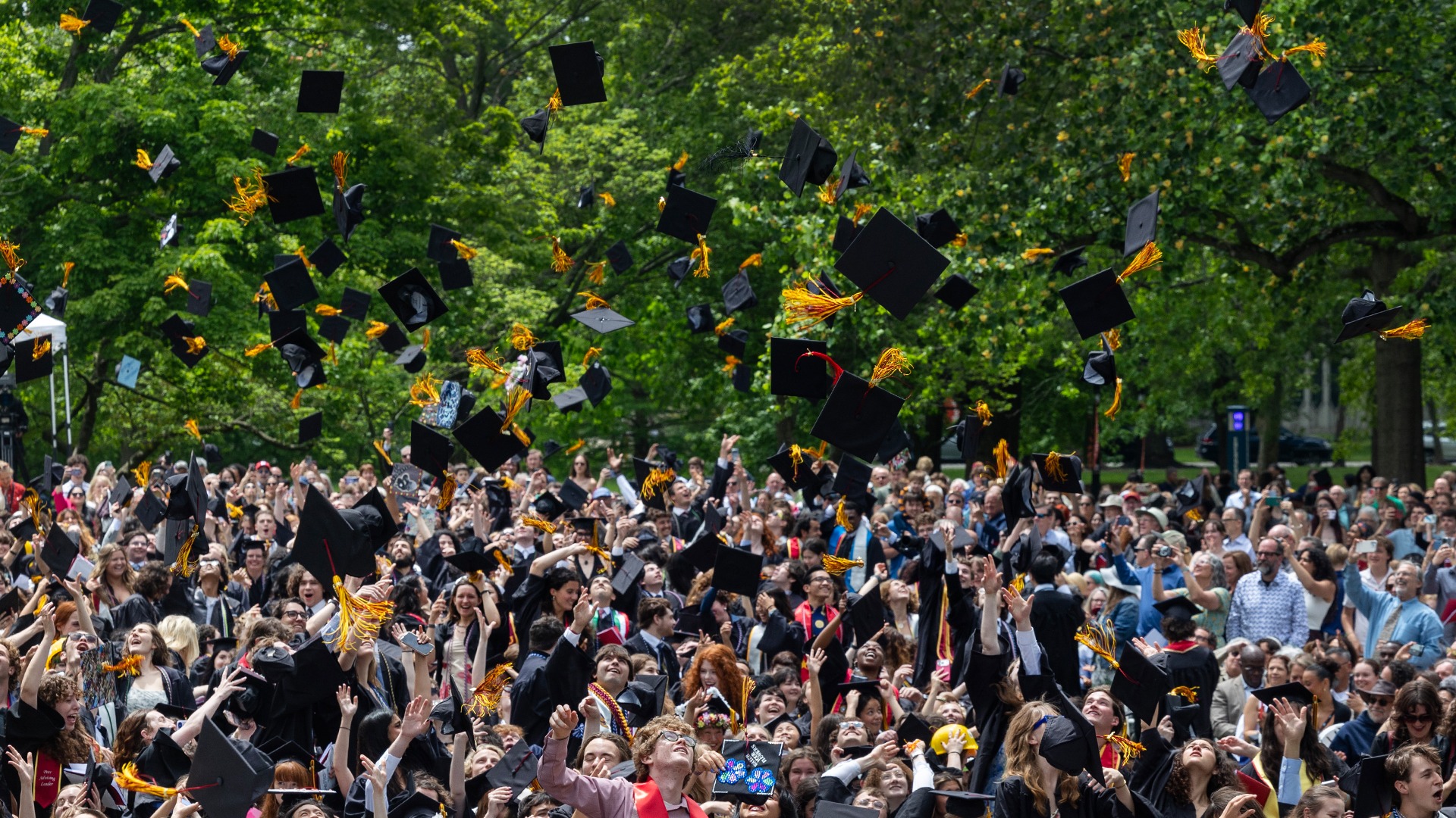 2026 graduates throwing their caps