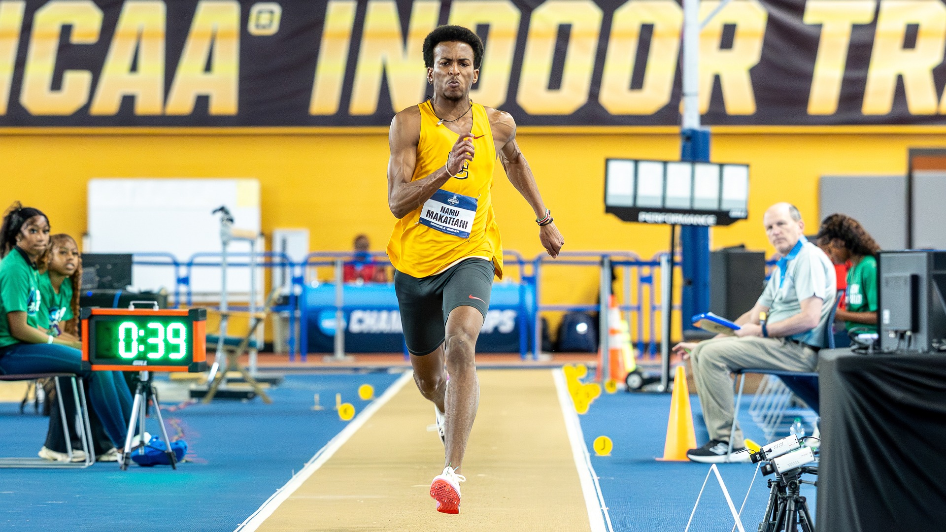 Namu Makatiani runs down the runway before attempting the triple jump at the NCAA Indoor Championships