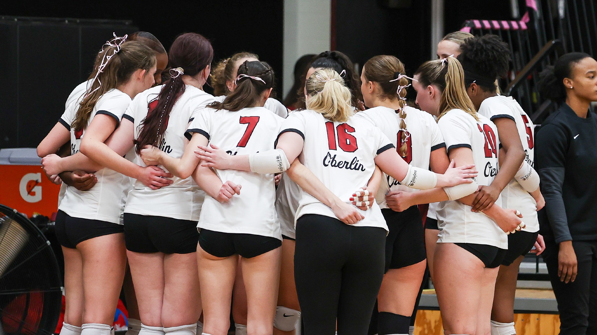 Volleyball team in a huddle before starting lineups