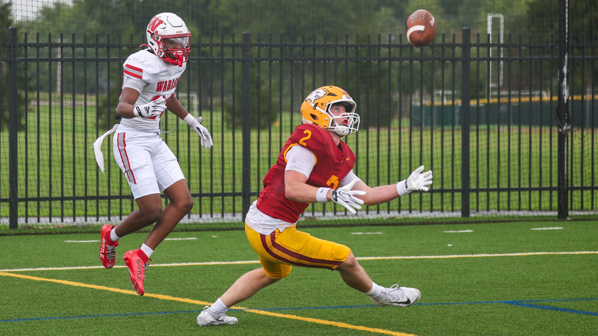 JJ Racz reaching for ball in the air in the endzone