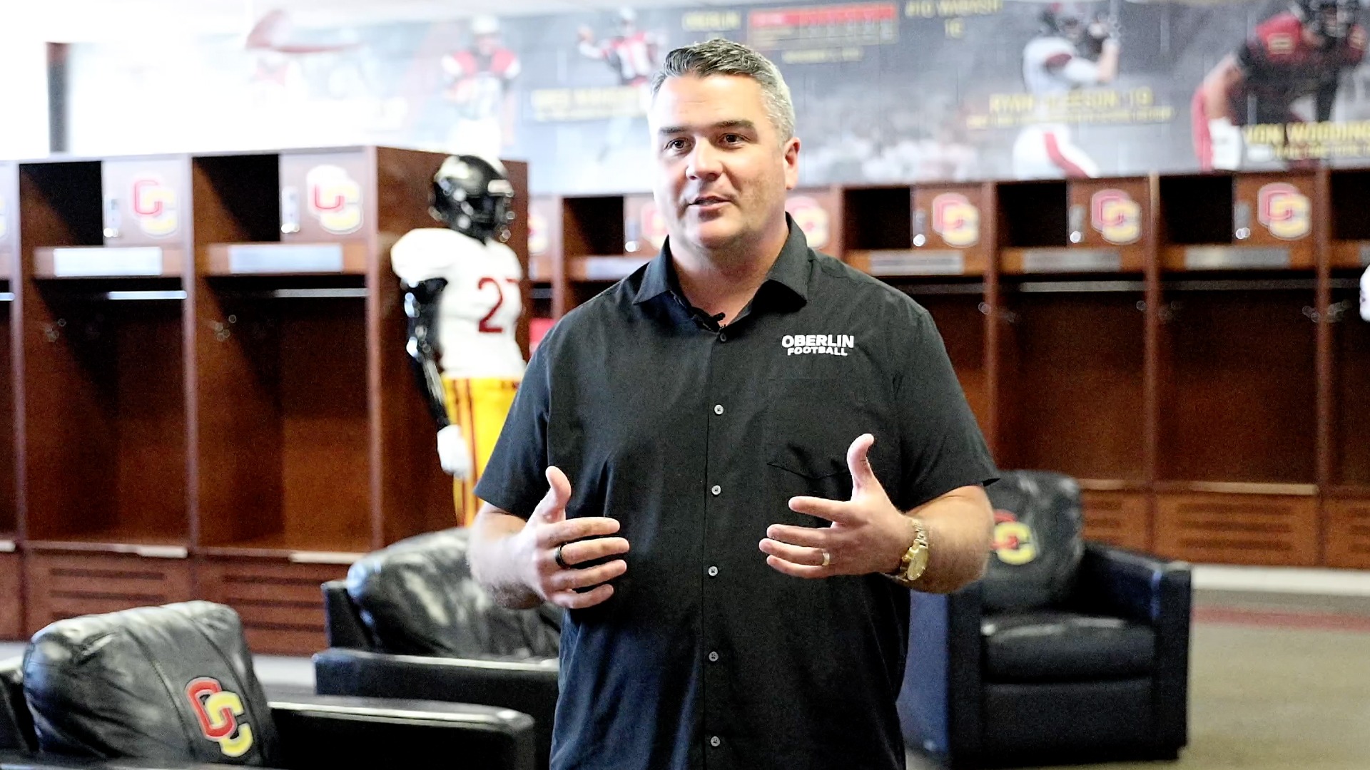 John Pont standing in locker room during an interview