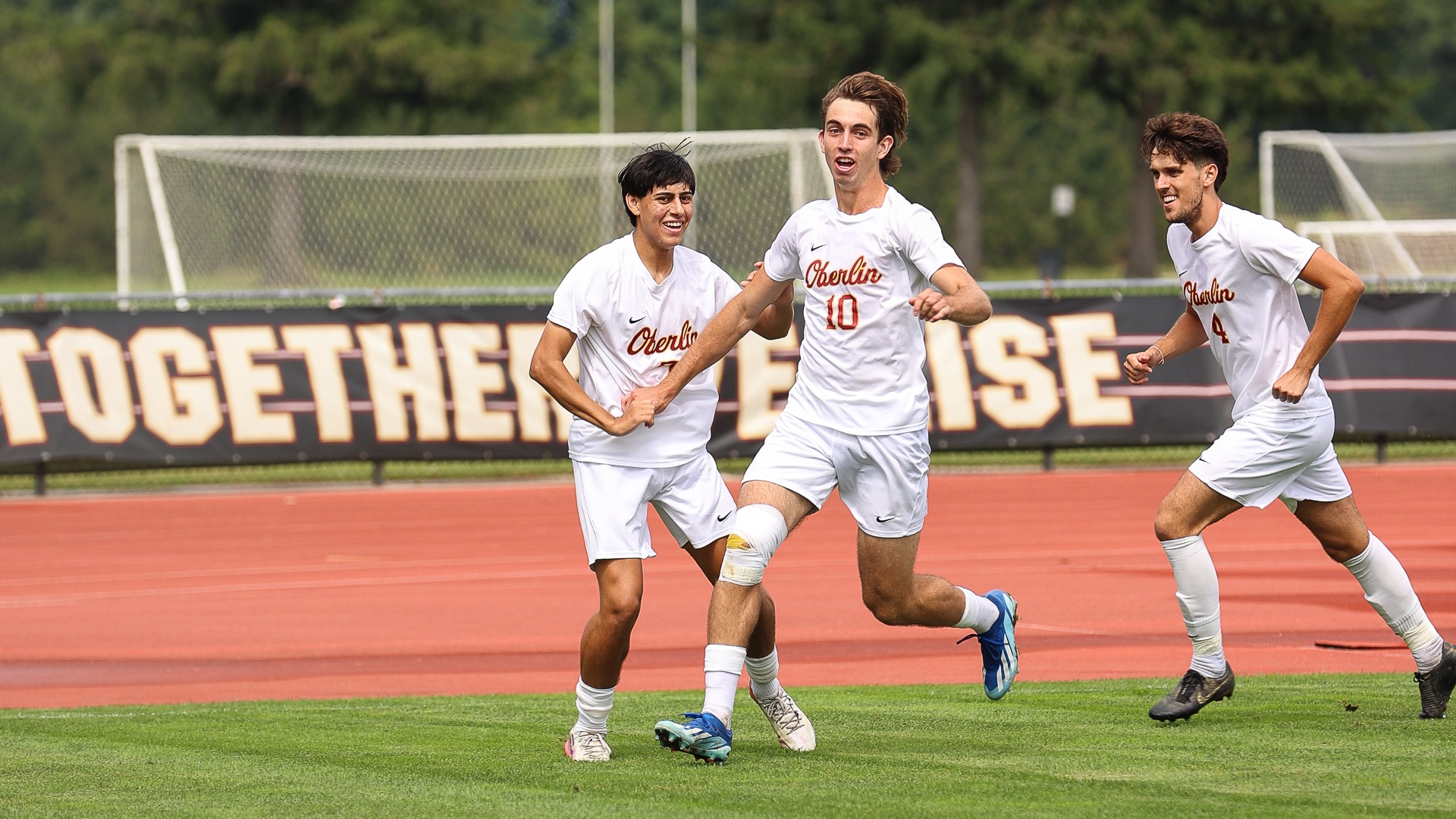 Michael Dolton running across field to celebrate a goal