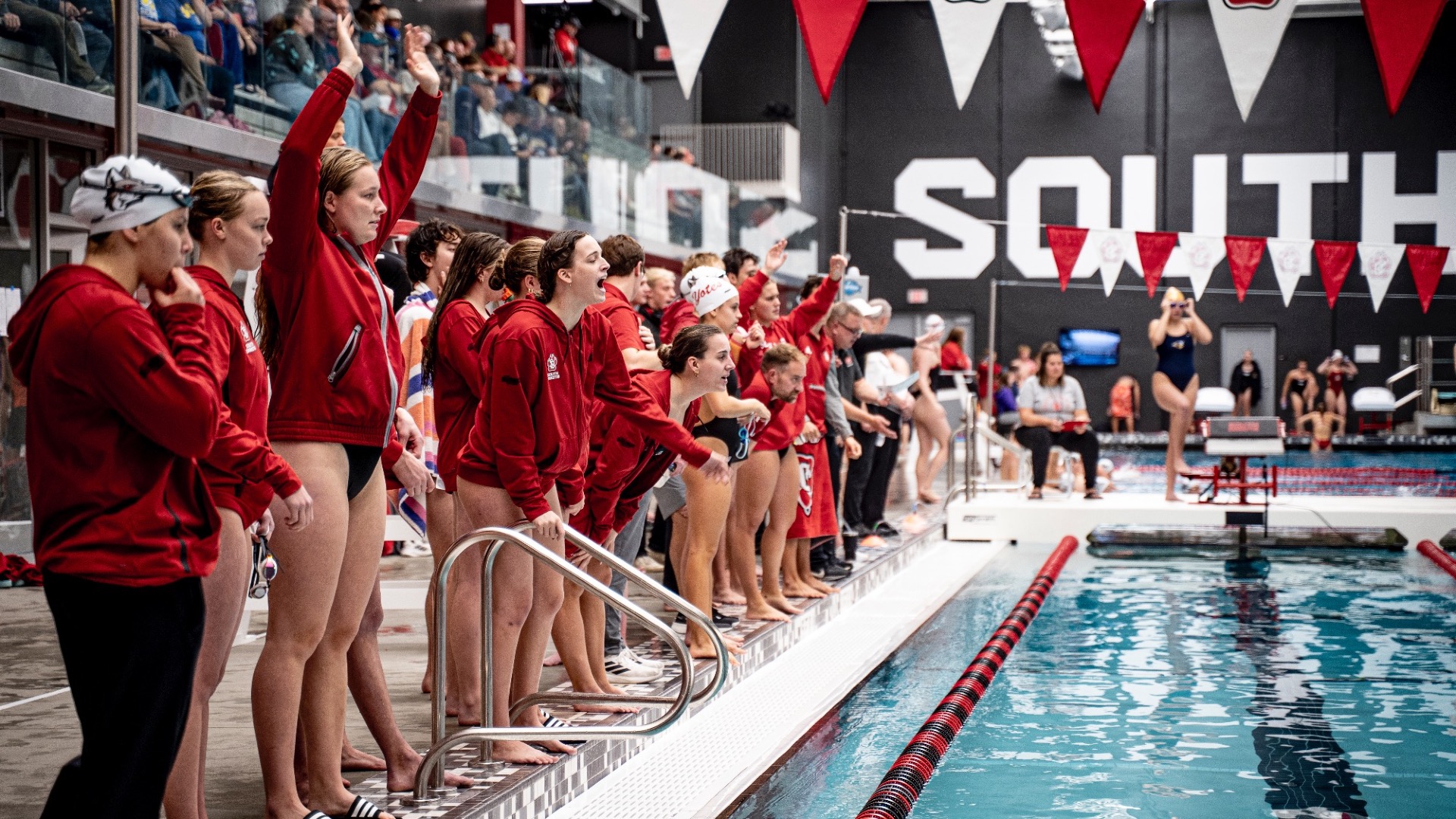 Swim team cheering on racers
