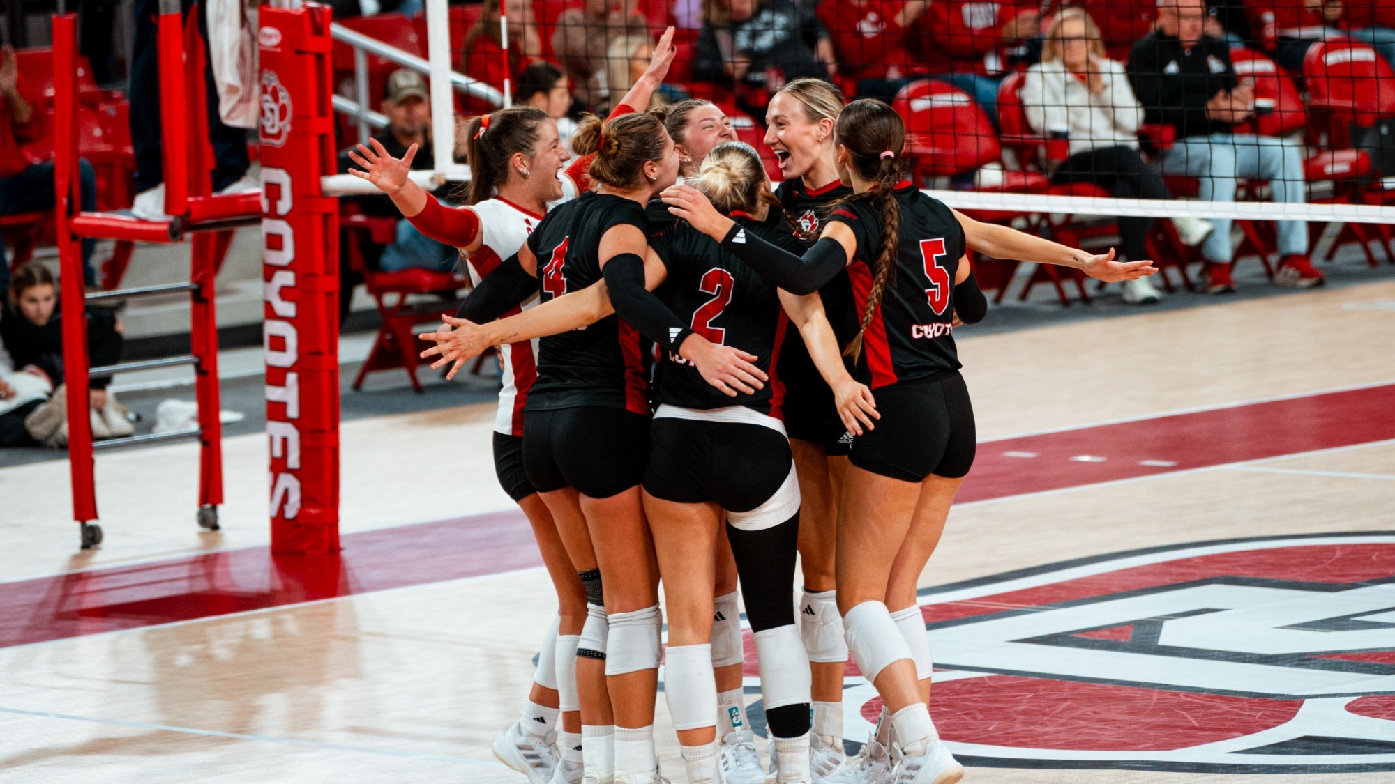 Volleyball team celebrating after a point against NDSU 111825