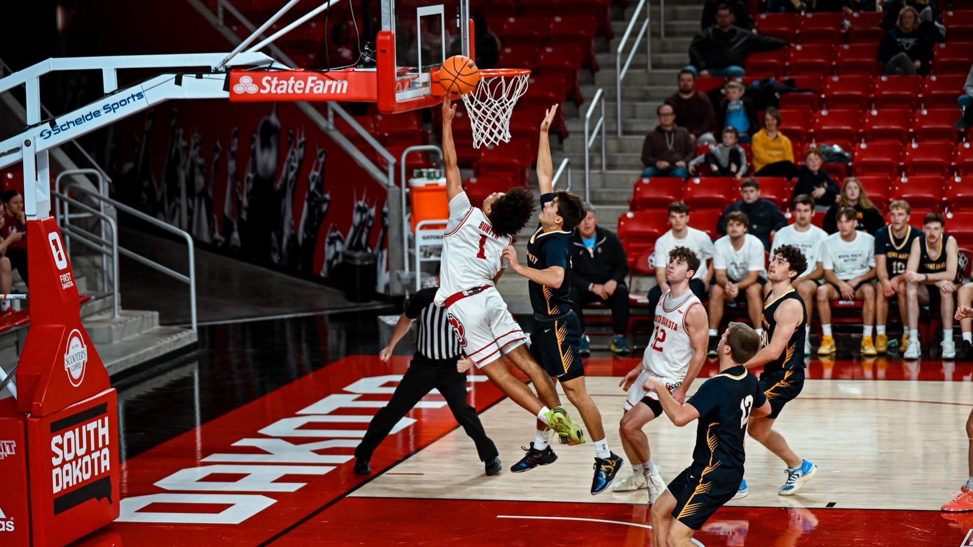Uzziah Buntyn going up for a layup against Mount Marty 122825