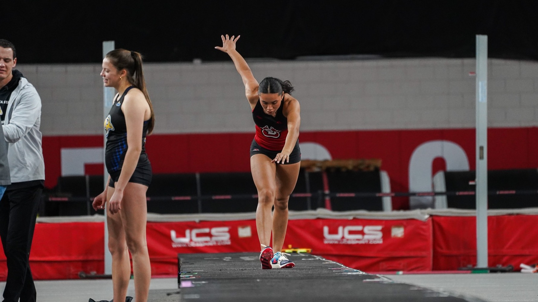 Matayah YellowMule starts her run for the triple jump inside the DakotaDome