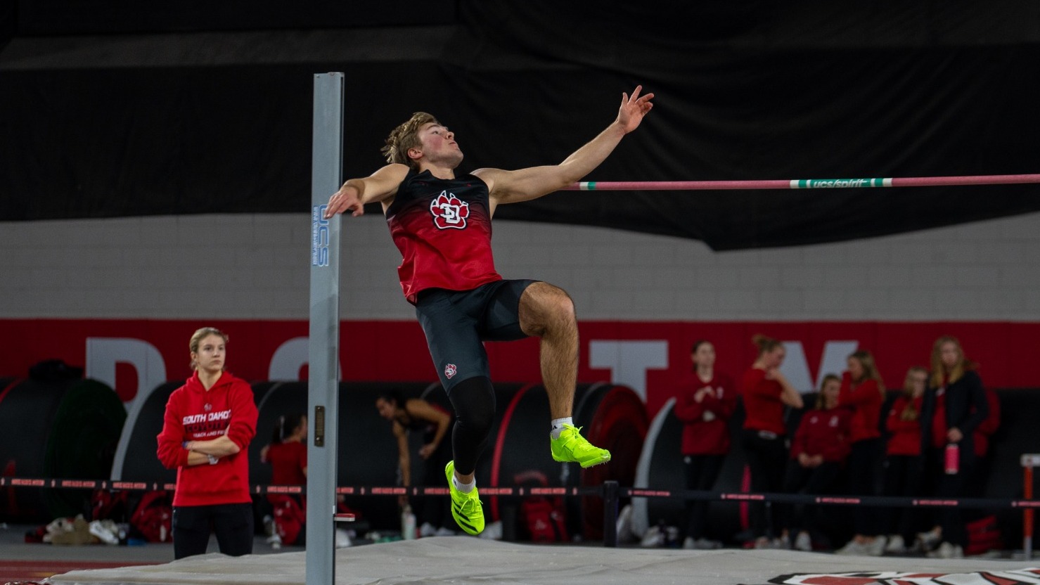 Landon Olson attempts to clear the high jump bar at the 2025 USD Alumni Meet