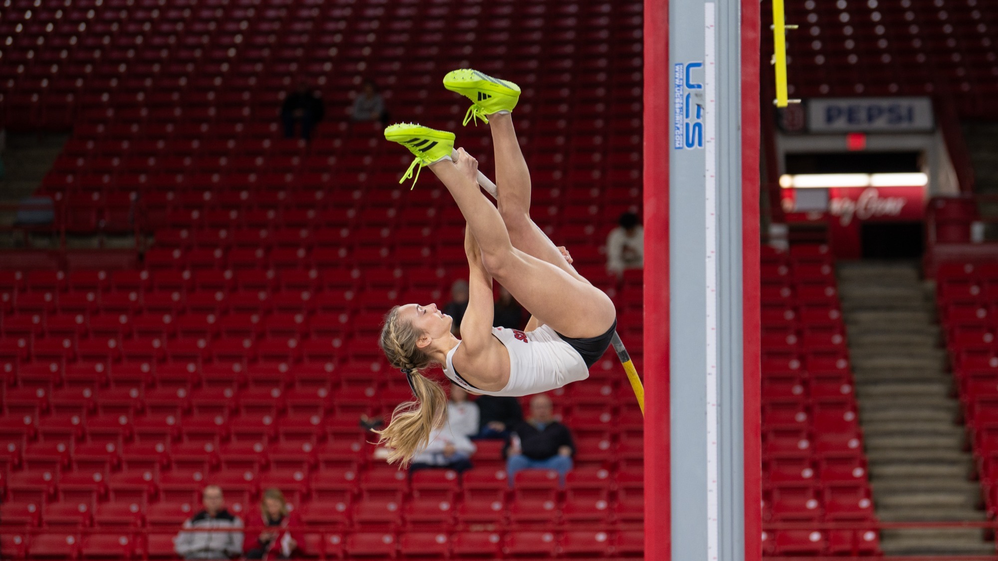 Anna Willis competes in the pole vault at the USD Alumni Meet