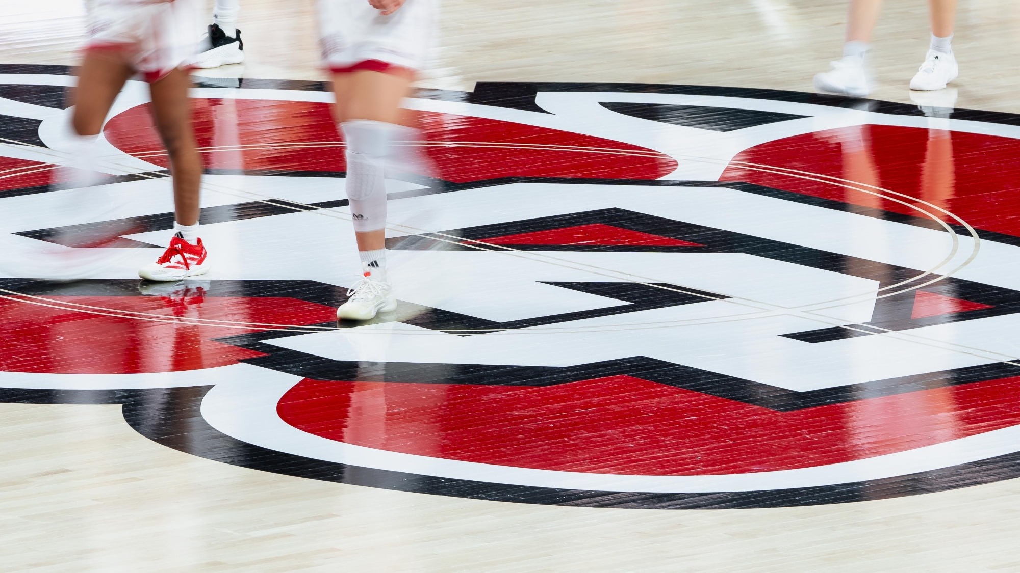 Players run across the midcourt logo in the SCSC earlier this season