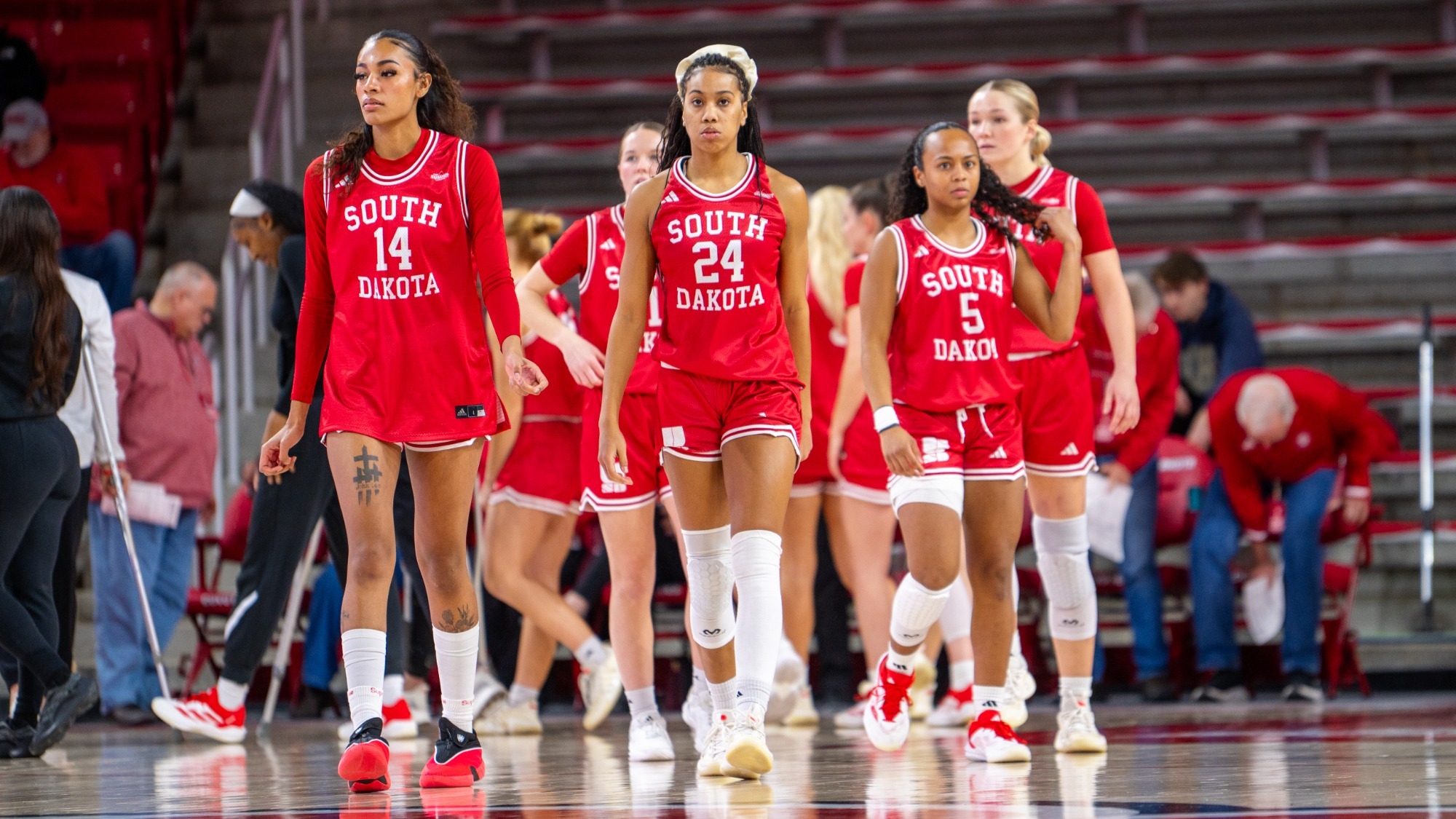 Josie Hill, Elise Turrubiates, and Angelina Robles walk onto the court