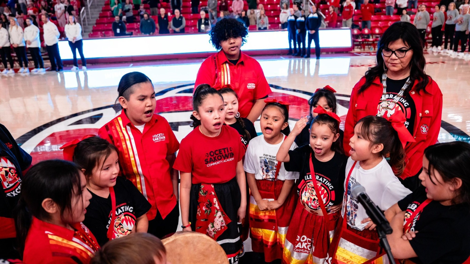 A group of young Native American students perform prior to a women's basketball game in the SCSC