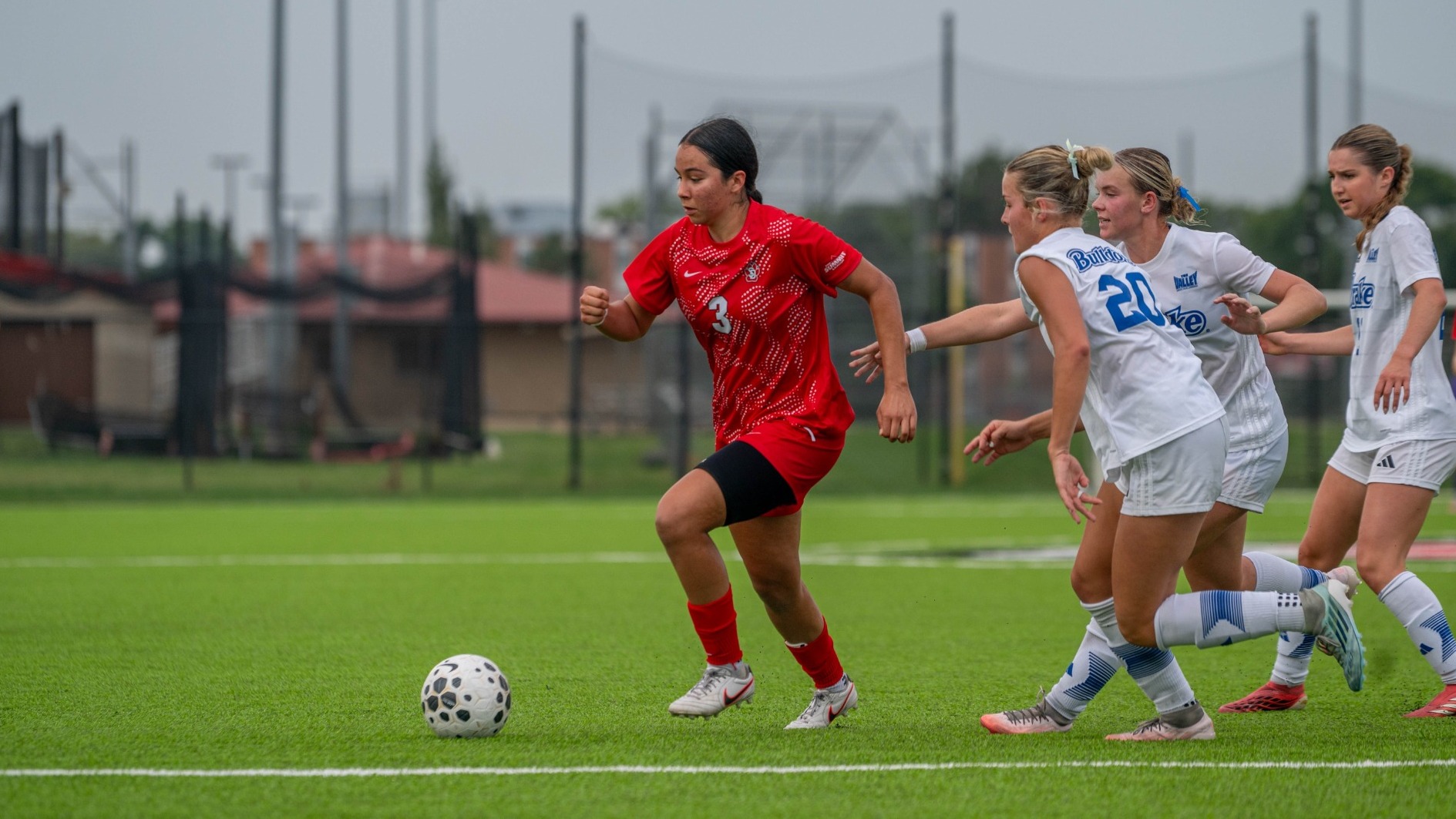 Klarissa Vega driving past Drake defenders.