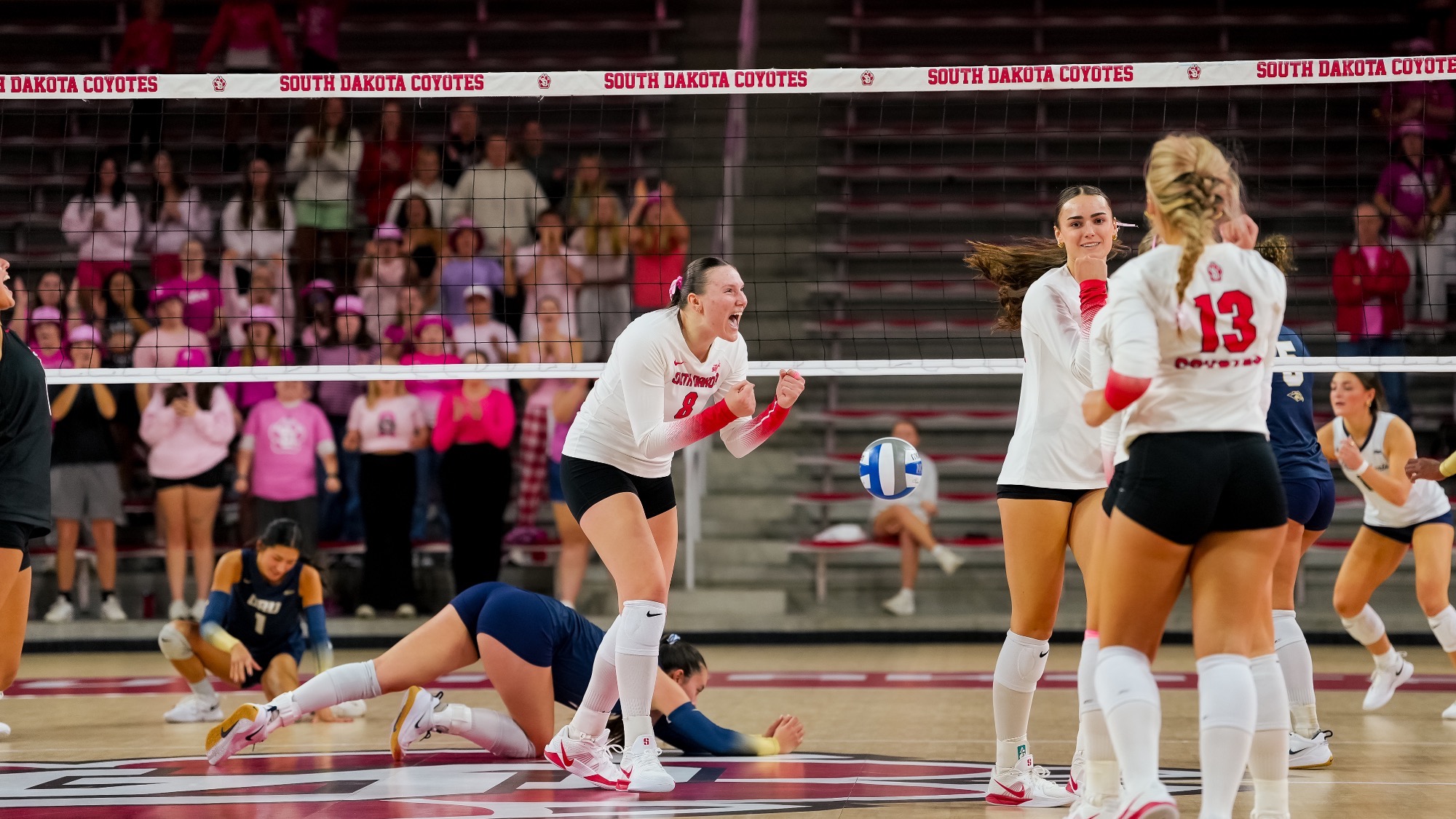 Morgan Bode and Audrey Nelson celebrating a point against ORU 2026