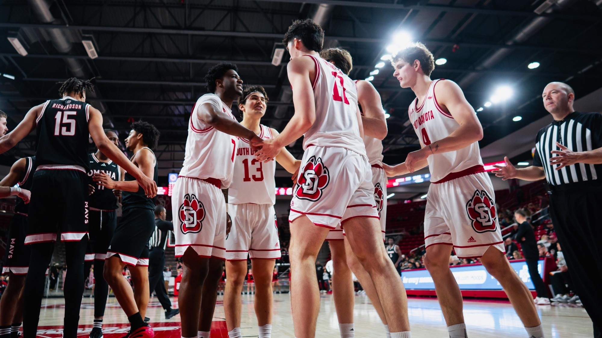 South Dakota men's basketball player huddle after an and-one against Omaha 022426