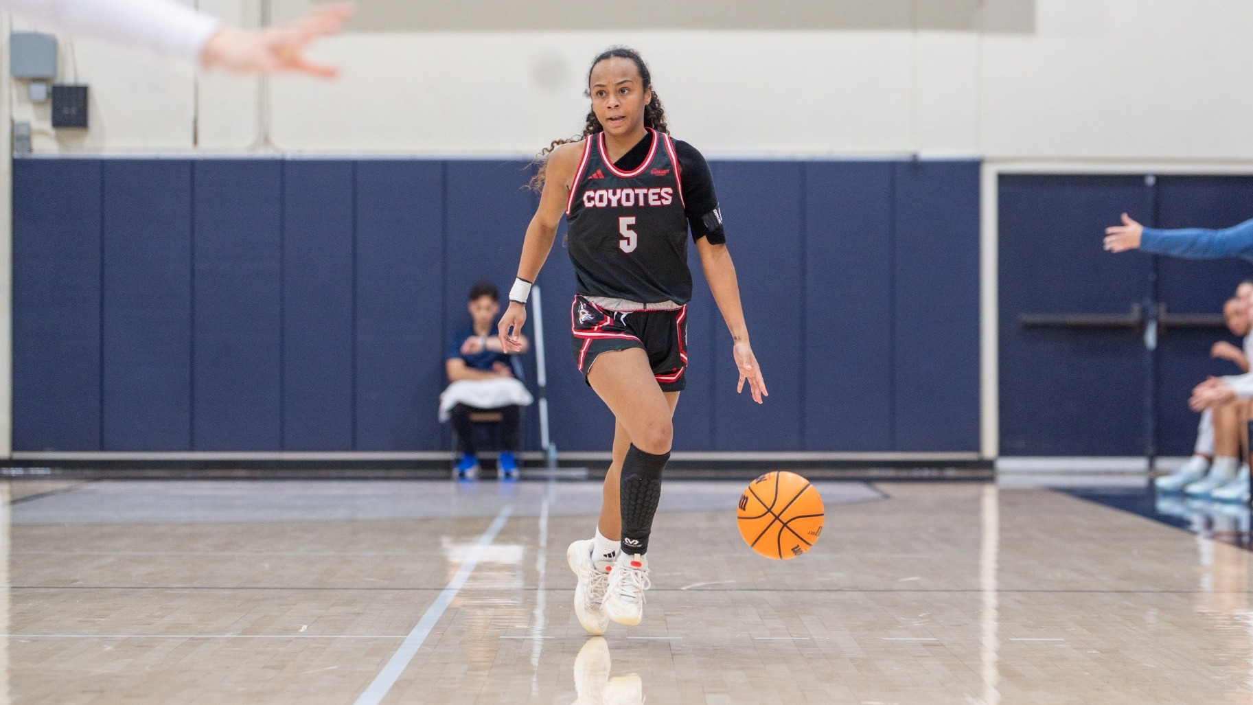 Angelina Robles dribbles the basketball during a game