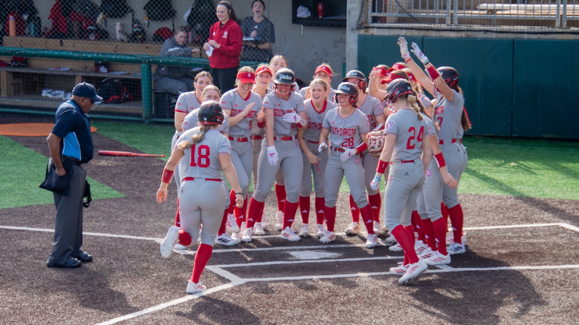Delaney White celebrates with team after hitting grand slam