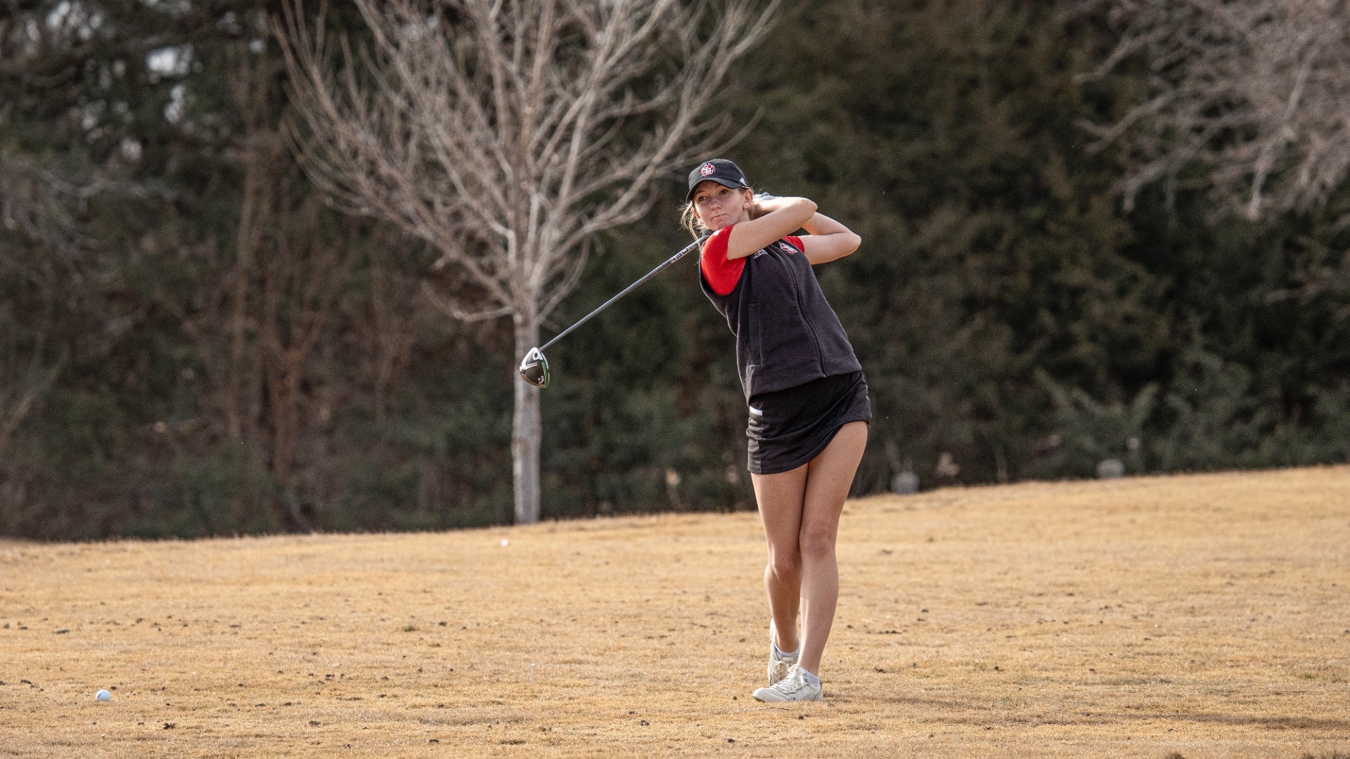 Eva Greenberg hitting a ball at the Bluffs