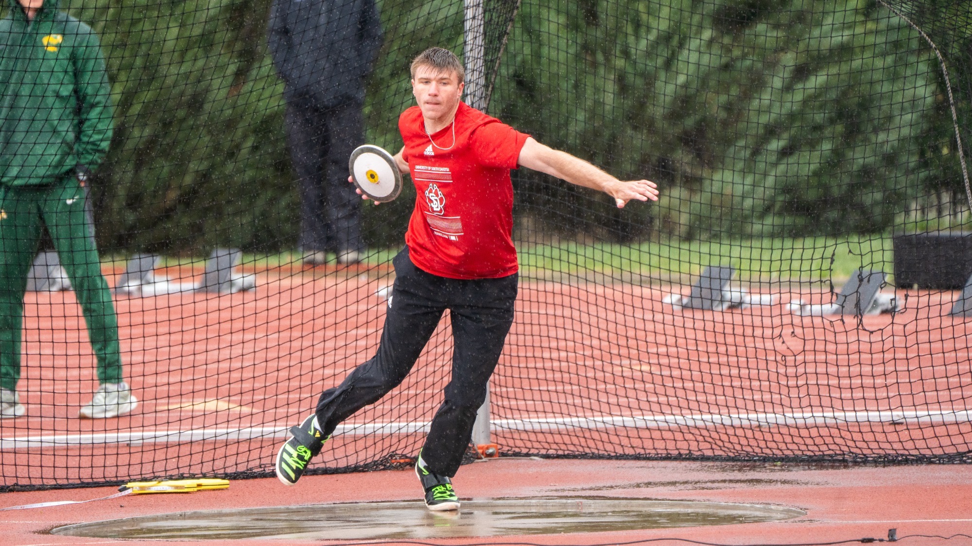 Townsend Barton competes in the discus during a rain shower 