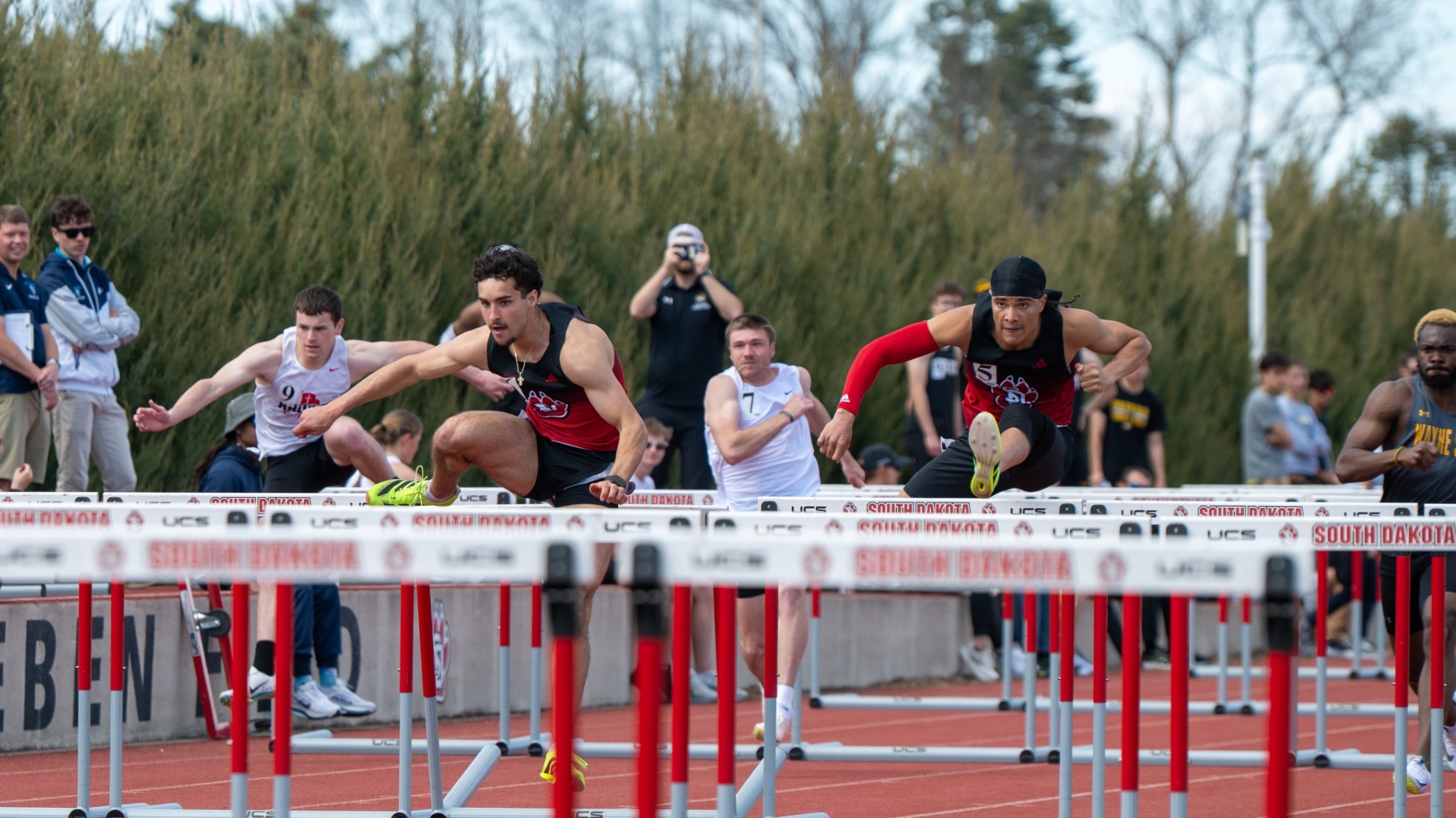 Jaden Damiano and Mikael Grace compete in the 110-meter hurdles at the USD Snooze Button Classic